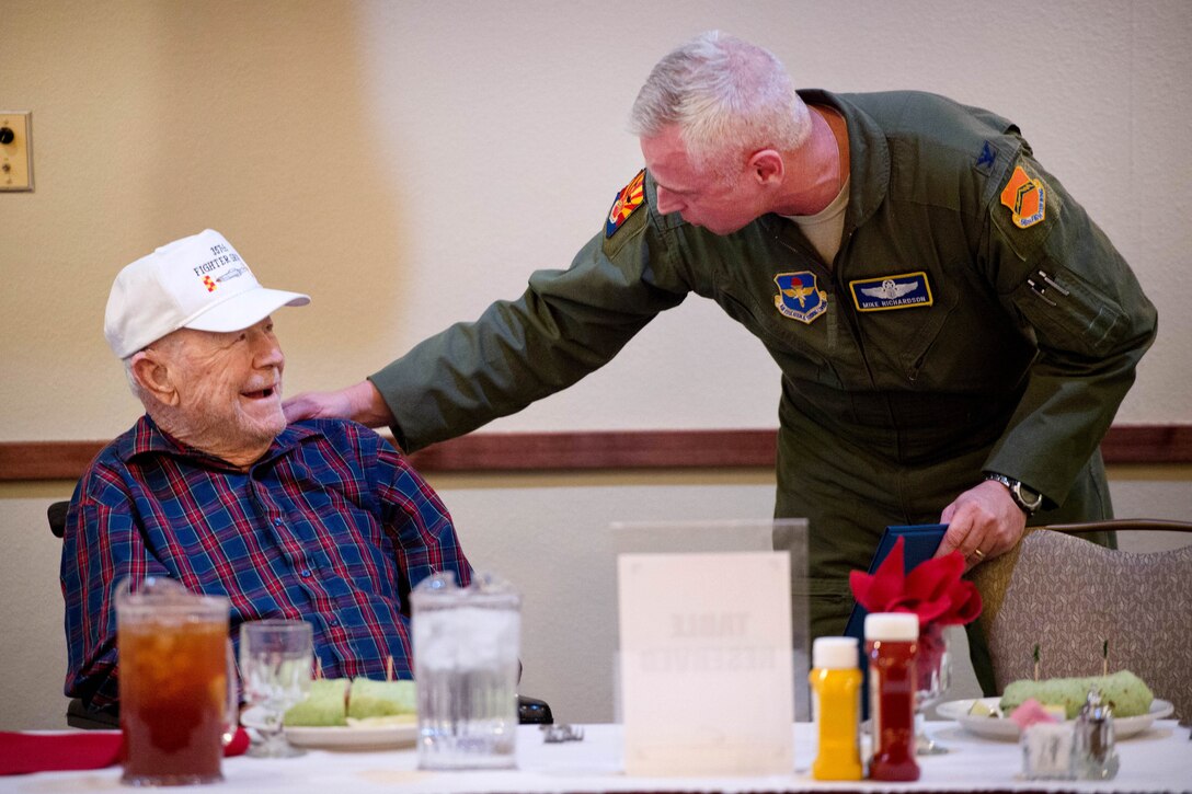 Retired Air Force Brig. Gen. Chuck Yeager receives words of appreciation from Col. Michael Richardson.