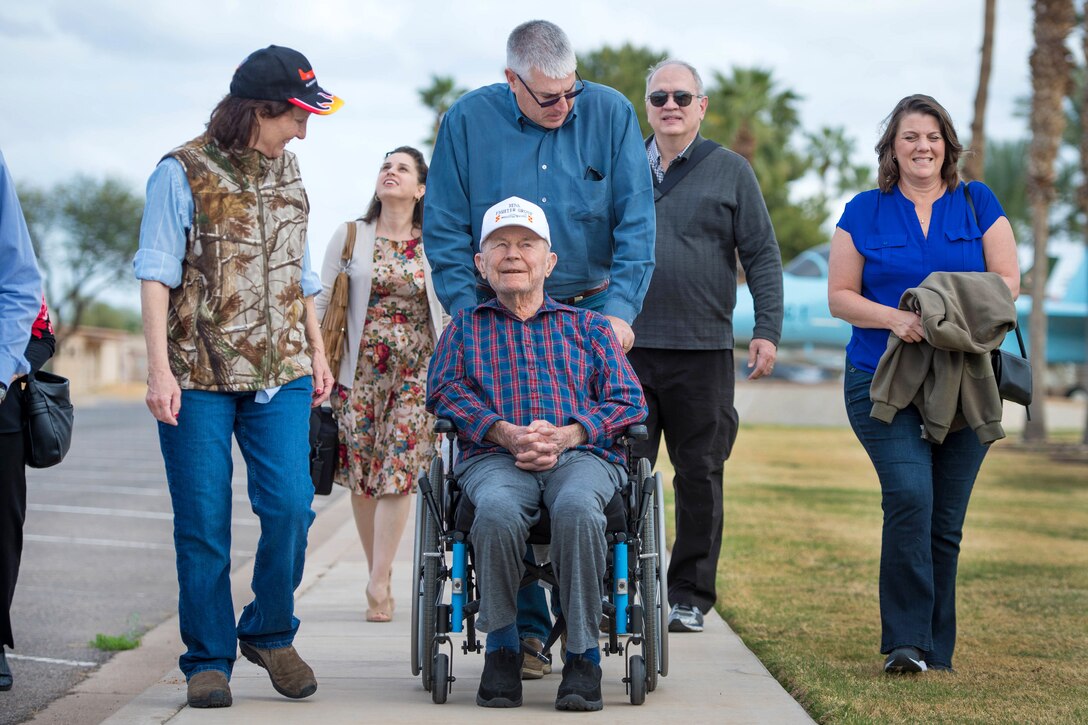 Retired Air Force Brig. Gen. Chuck Yeager is assisted around the air park during a tour.