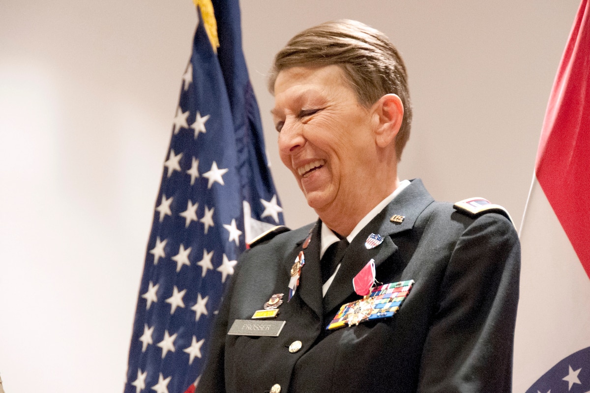 A soldier smiles during a ceremony.