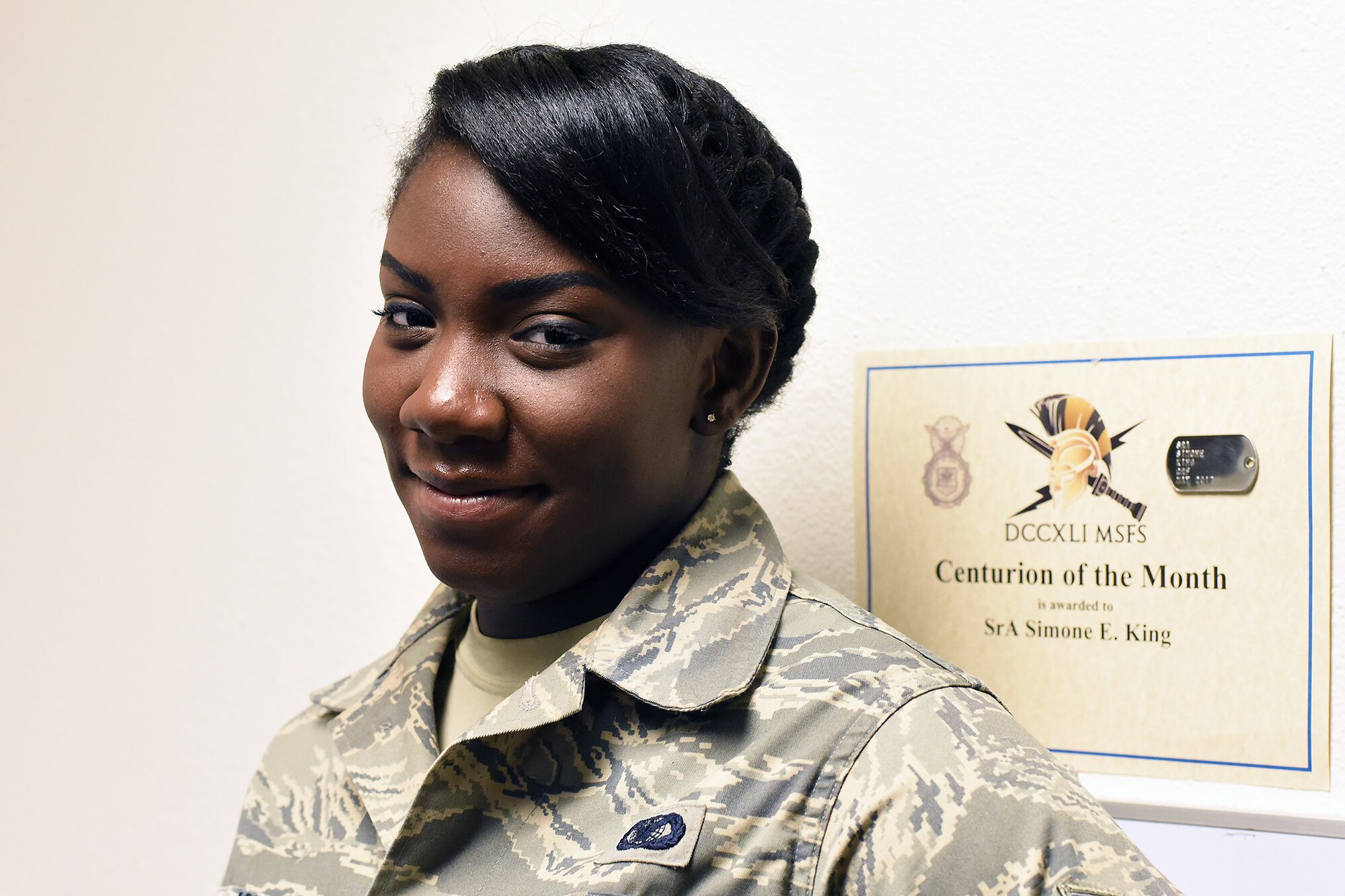 Senior Airman Simone King, 341st Security Forces Support Squadron commander support staff, poses in her office Feb. 21, 2018, at Malmstrom Air Force Base, Mont. King brings her voice and perspective to the Malmstrom community discussing Black History Month. (U.S. Air Force photo by Kiersten McCutchan)