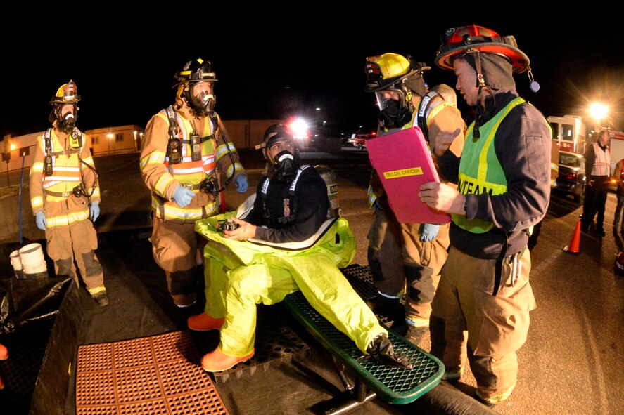 Fire Captain Joe Kuropatwa (center), decontamination officer, clarifies procedures with fellow firefighters during an emergency response exercise Jan. 30, 2018, at Hill Air Force Base, Utah. (U.S. Air Force photo by Todd Cromar)