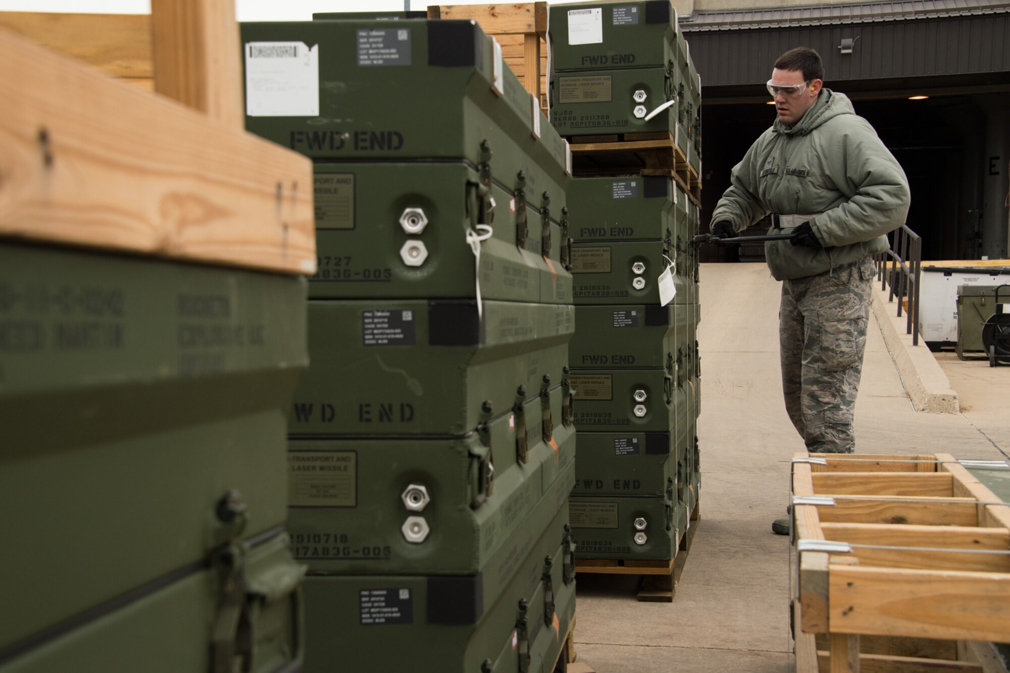 Airmen 1st Class Justin Stoeckle, 649th Munitions Squadron, removes banding from munition pallets during a readiness exercise Jan. 30, 2018, at Hill Air Force Base, Utah. (U.S. Air Force photo by R. Nial Bradshaw)