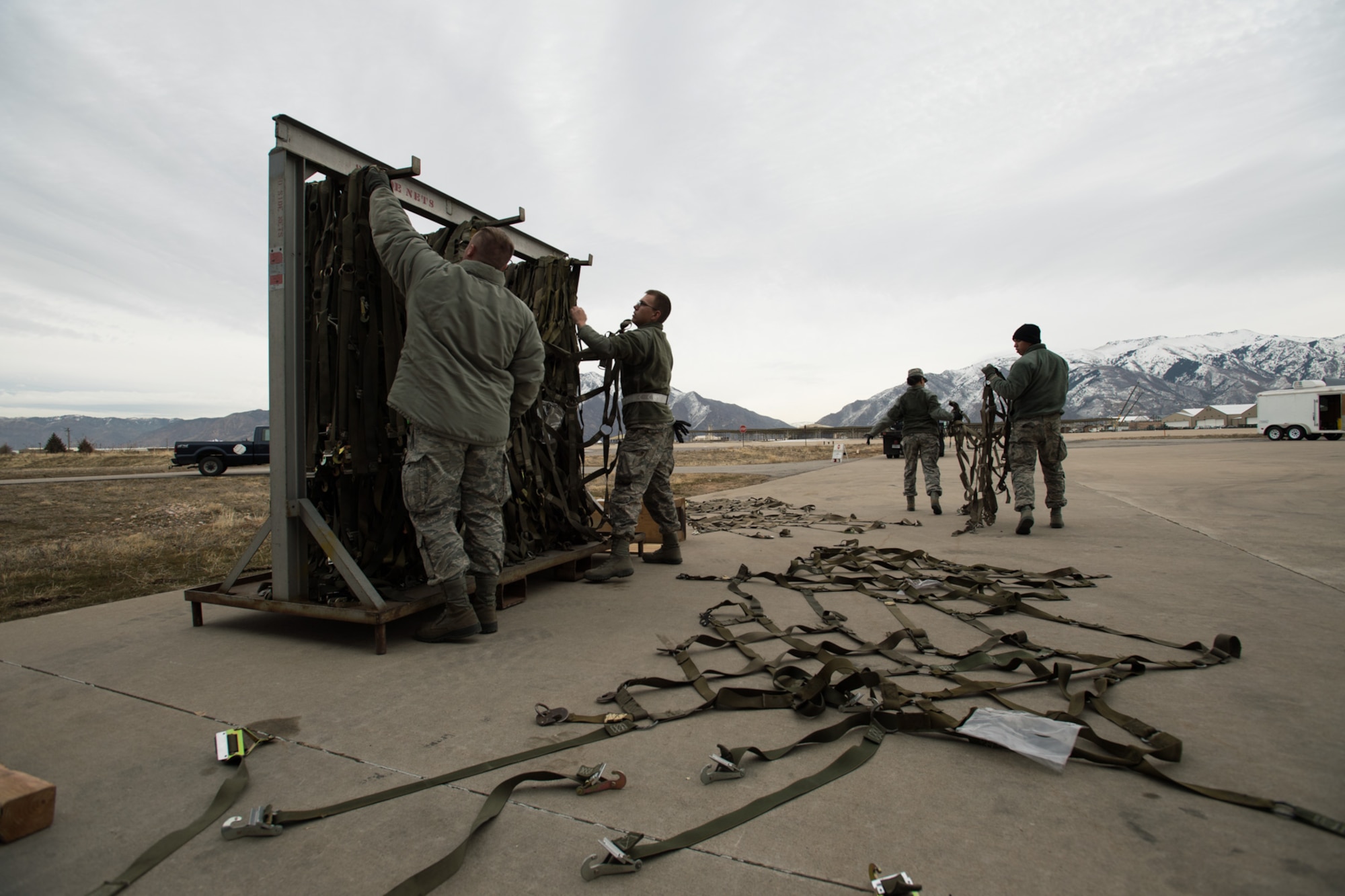 Airmen from the 649th Munitions Squadron prepare netting for munition pallets during a readiness exercise Jan. 30, 2018, at Hill Air Force Base, Utah. (U.S. Air Force photo by R. Nial Bradshaw)