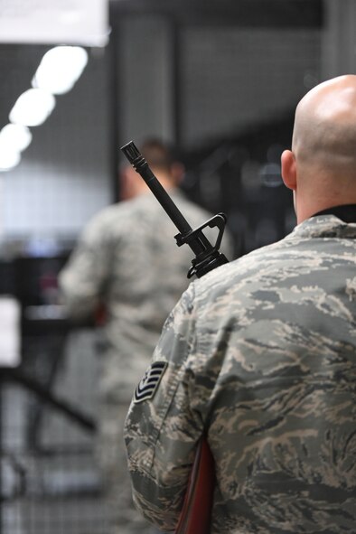 An Airman waits to return his weapon during a weapon issue simulation and readiness exercise Jan. 29, 2018, at Hill Air Force Base, Utah. Airmen simulated the process of filling their mobility bags, weapon issue, and going through a pre-deployment function line. (U.S. Air Force photo by Cynthia Griggs)