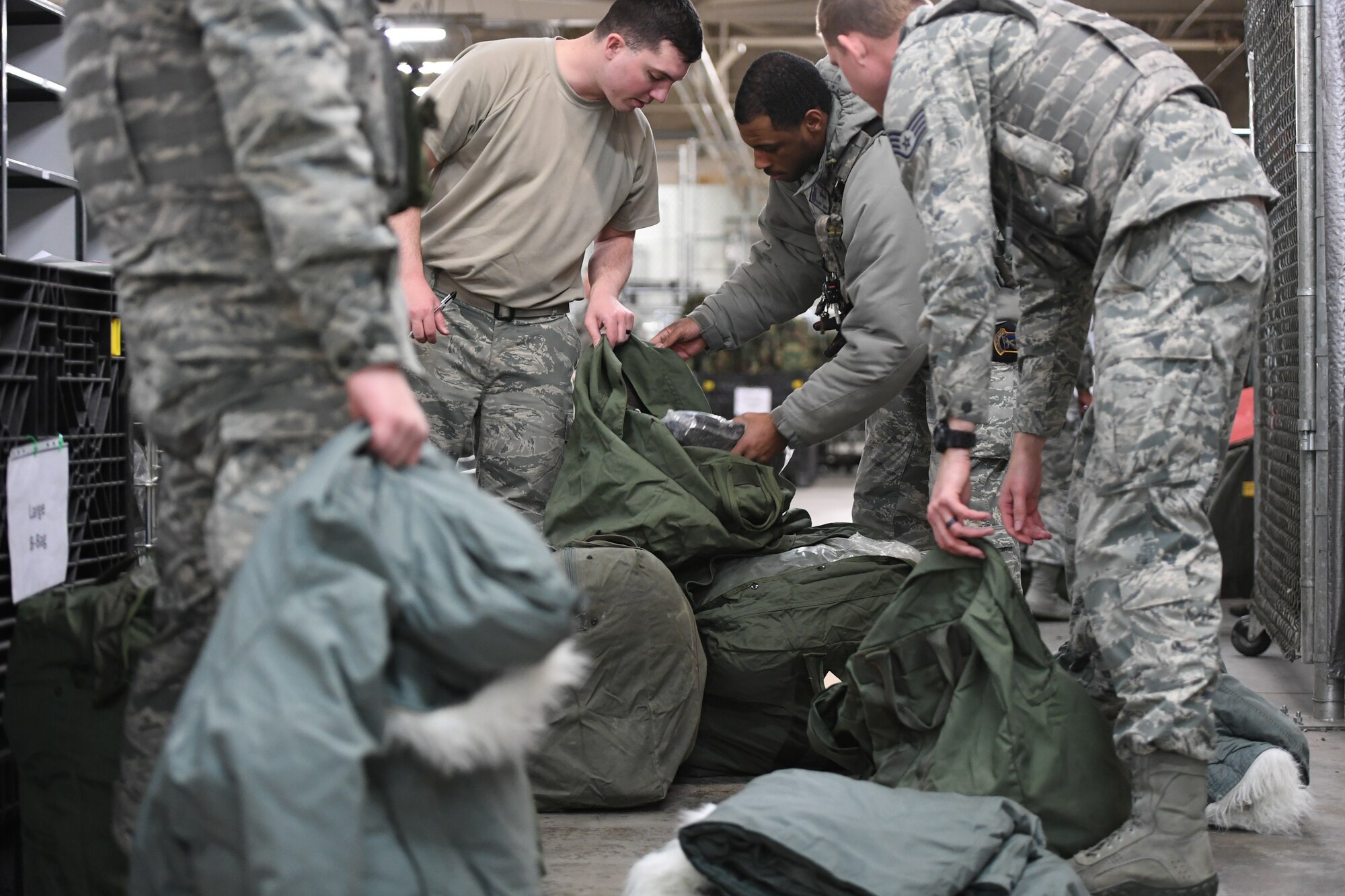 Airmen fill their mobility bags during a readiness exercise Jan. 29, 2018, at Hill Air Force Base, Utah. Airmen simulated the process of filling their mobility bags, weapon issue, and going through a pre-deployment function line. (U.S. Air Force photo by Cynthia Griggs)