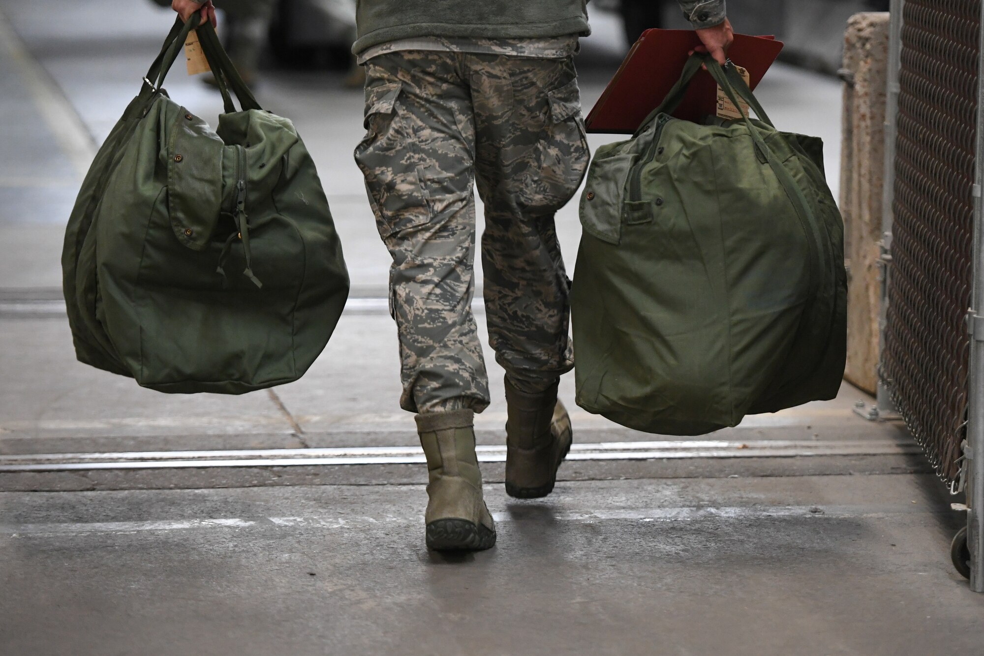 Airmen load mobility bags during a readiness exercise Jan. 29, 2018, at Hill Air Force Base, Utah. Airmen simulated the process of filling their mobility bags, weapon issue, and going through a pre-deployment function line. (U.S. Air Force photo by Cynthia Griggs)