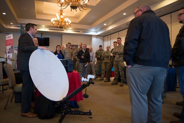 A technology company representative briefs 56th Fighter Wing leadership on new products during the 2018 Luke Tech Expo at Luke Air Force Base, Ariz., Feb. 22, 2018. The tech expo allowed wing leadership to view mission-centric technology exhibits from approximately 20 industry leaders in fields like telecommunications, cybersecurity, virtual reality and network management. (U.S. Air Force photo/Senior Airman Ridge Shan)