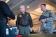 Col. Michael Richardson, 56th Fighter Wing vice commander, and Maj. Nathaniel Edwards, 56th Communications Squadron commander, listen to a technology company representative as he briefs them on new technology solutions during the 2018 Luke Tech Expo at Luke Air Force Base, Ariz., Feb. 22, 2018. The tech expo demonstrated numerous technologies and advancements in communications and other fields related to the mission of the 56th Fighter Wing. (U.S. Air Force photo/Senior Airman Ridge Shan)