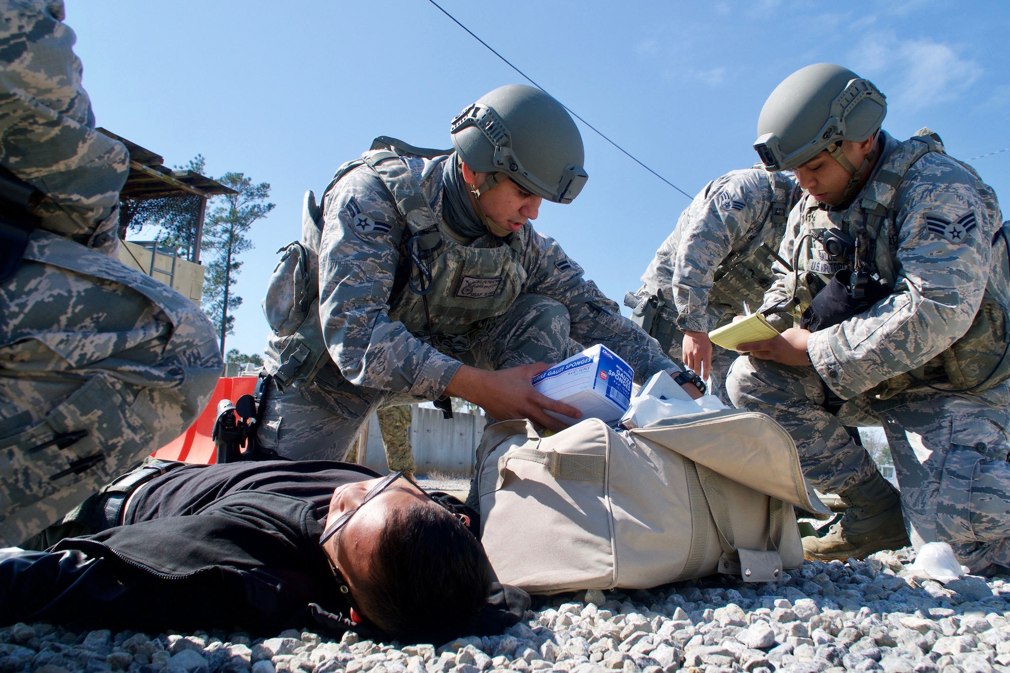 Airman First Class David Lovell Pieper Victorino, 154th Security Forces Squadron fire team member, provides simulated medical care to an injured civilian during Patriot South exercise, Feb. 13, 2018, at Camp Shelby, Mississippi.