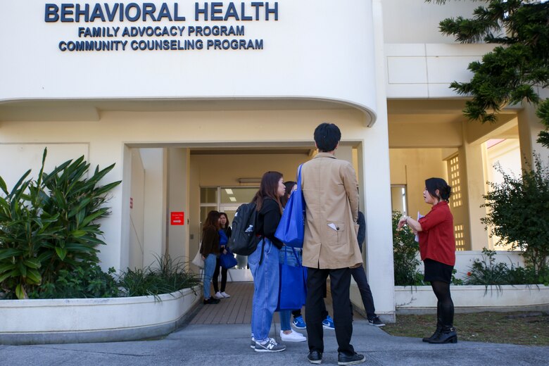 Maki Takahashi leads students to the different sections of the behavioral health center during a seminar Feb. 15 aboard Camp Foster, Okinawa, Japan. The seminar presented 23 students from Okinawa International University with information on the different types of programs offered to service members and their families. The students learned about the community counselling program, family advocacy program and substance abuse counselling programs offered to Marines, sailors and their families. (U.S. Marine Corps photo by Pfc. Nicole Rogge)