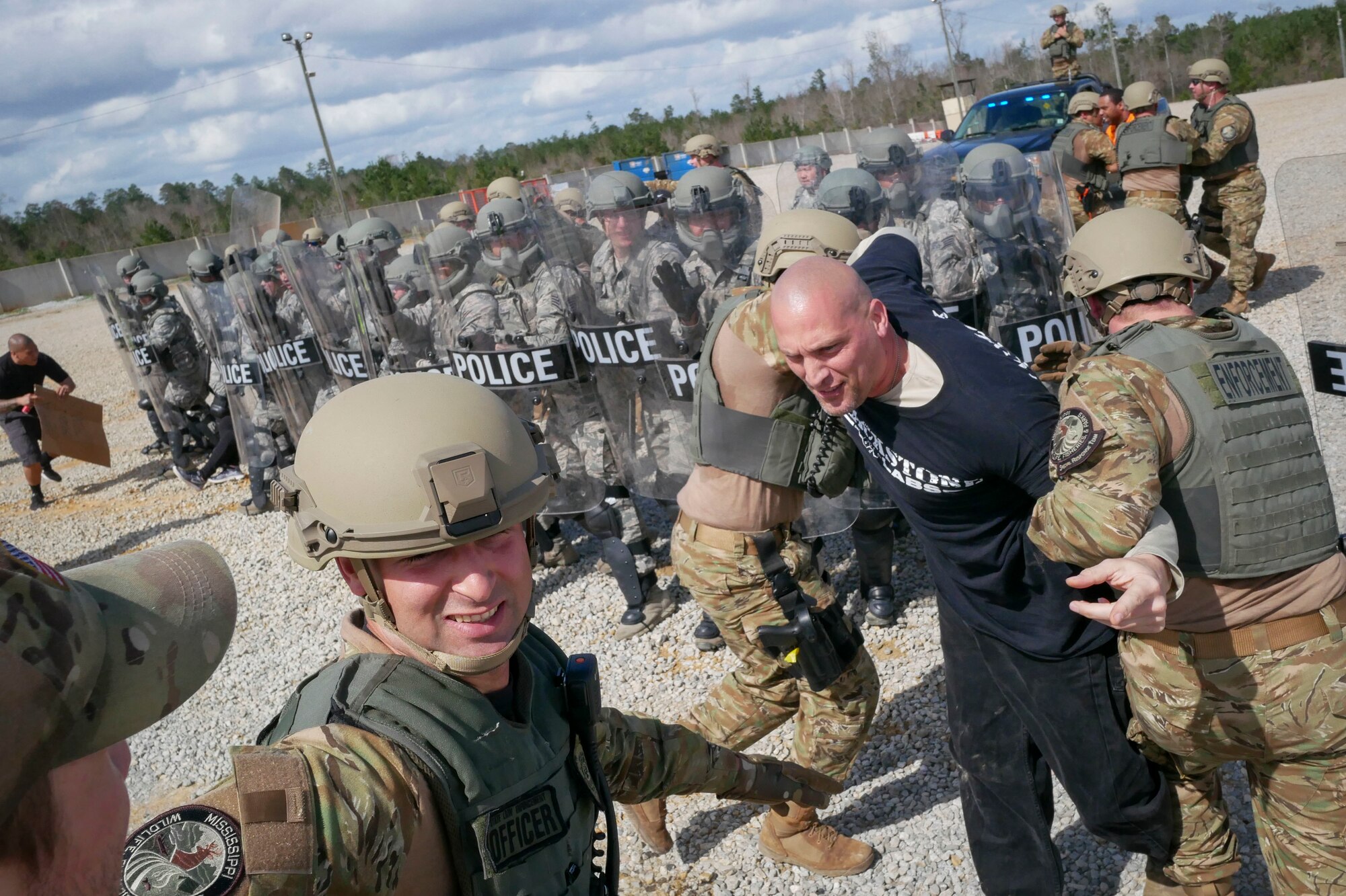 Members of the Mississippi Department of Wildlife, Fisheries and Parks Special Response Team apprehend Master Sgt. Joshua Go Forth, 129th Security Forces Squadron squad leader, during a training exercise Feb. 15, 2018, at Camp Shelby, Mississippi.