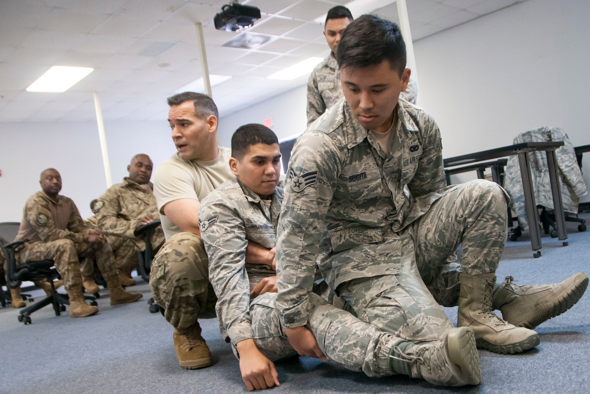 Master Sgt. Jose Alveida (left), 165th Air Support Operations Squadron, demonstrates a method of transporting an injured victim to members of the 154th Security Forces Squadron and the Mississippi Department of Wildlife, Fisheries and Parks Special Response Team Feb. 12, 2018, at Gulfport Combat Readiness Training Center, Mississippi.