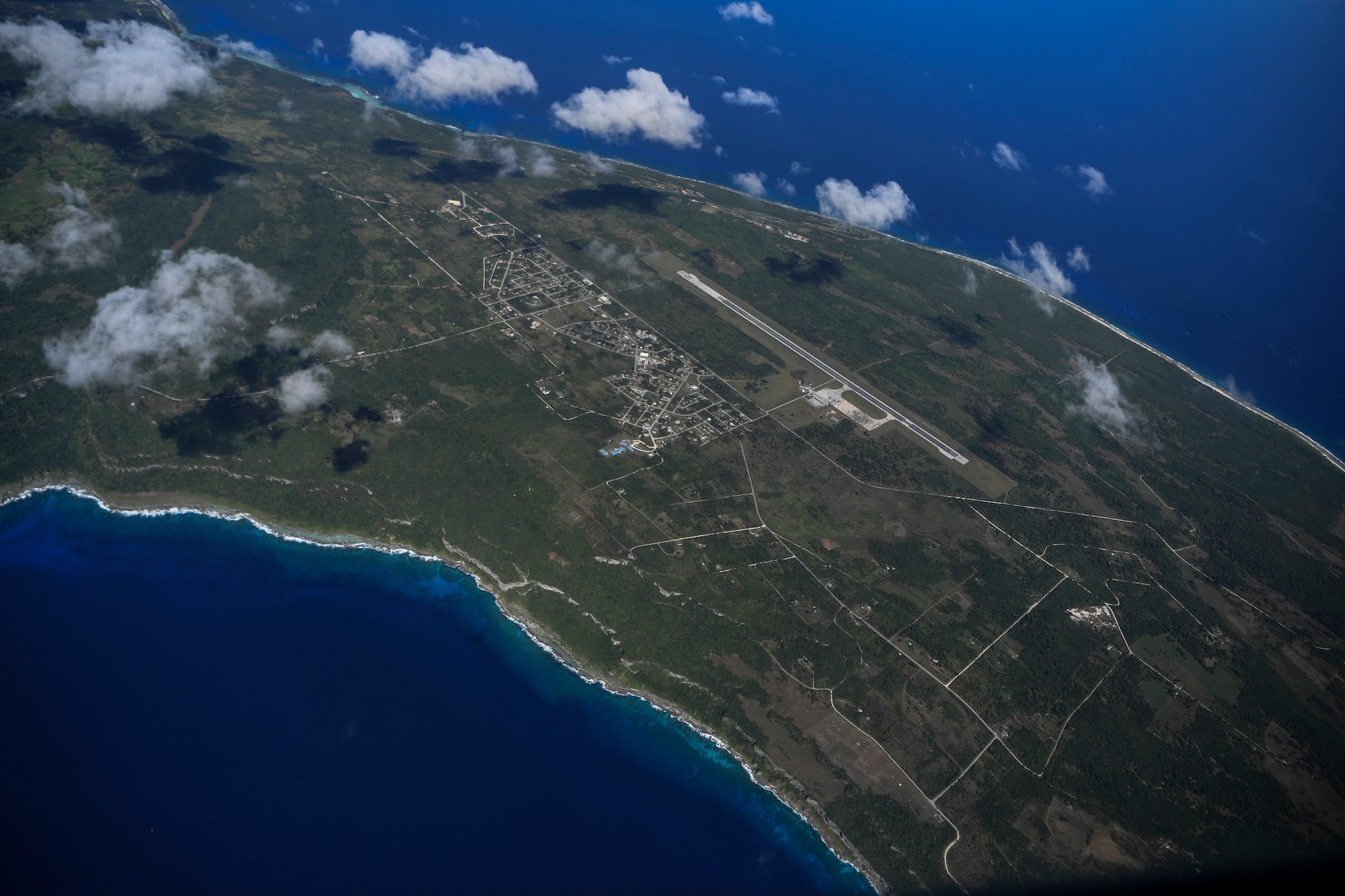 A U.S. Air Force C-130J Super Hercules flies over Tinian, U.S. Commonwealth of the Northern Mariana Islands, during an aeromedical evacuation mission during exercise COPE NORTH 18, Feb. 19.