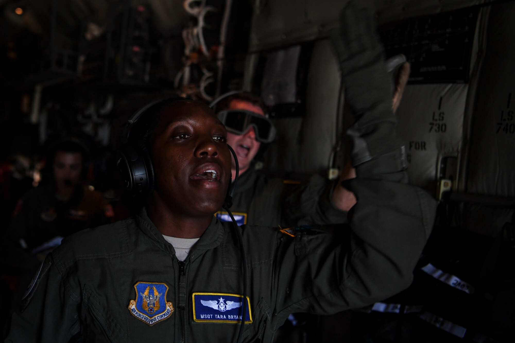 U.S. Air Force Master Sgt. Tara Bryant, 349th Aeromedical Evacuation Squadron technician, communicates with her crew during an aeromedical mission at Saipan, U.S. Commonwealth of the Northern Mariana Islands, during exercise COPE NORTH 18, Feb. 19.