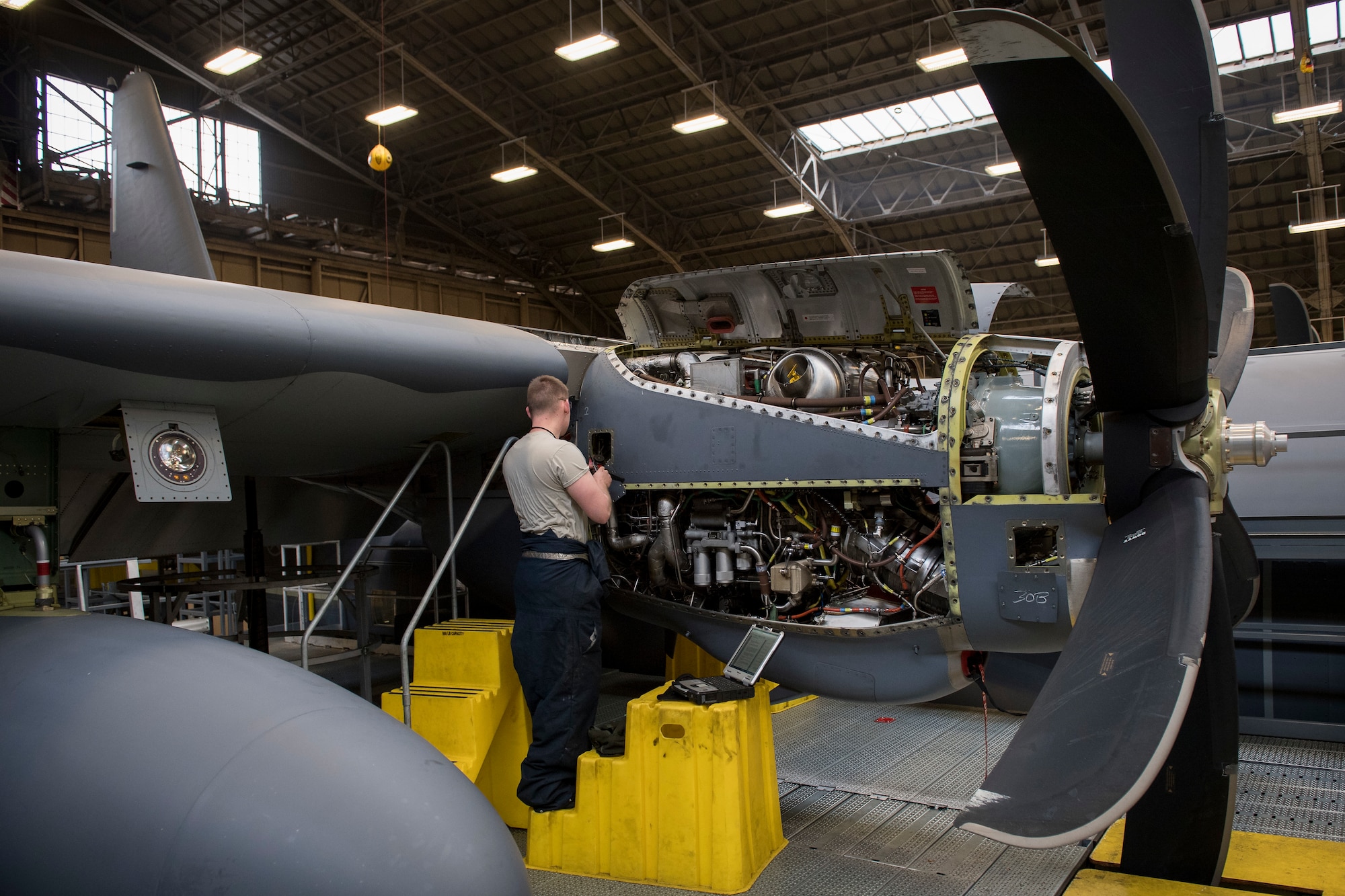 Senior Airman Alexander Forest, 374th Maintenance Squadron maintainer, installs safety cable for fire-loop connections on a C-130J Super Hercules’ Rolls Royce AE2100D3 engine, Feb. 22, 2018, at Yokota Air Base, Japan.