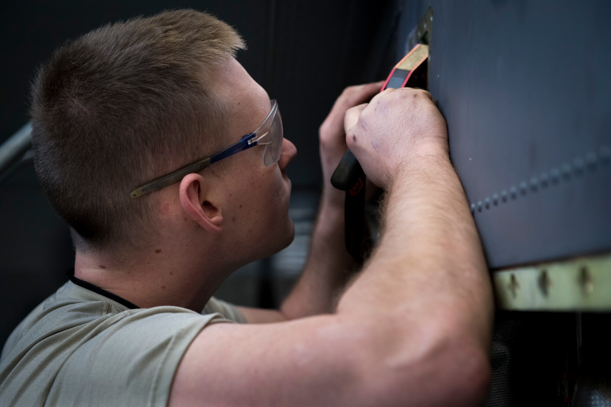 Senior Airman Alexander Forest, 374th Maintenance Squadron maintainer, installs safety cable for fire-loop connections on a C-130J Super Hercules’ Rolls Royce AE2100D3 engine, Feb. 22, 2018, at Yokota Air Base, Japan.