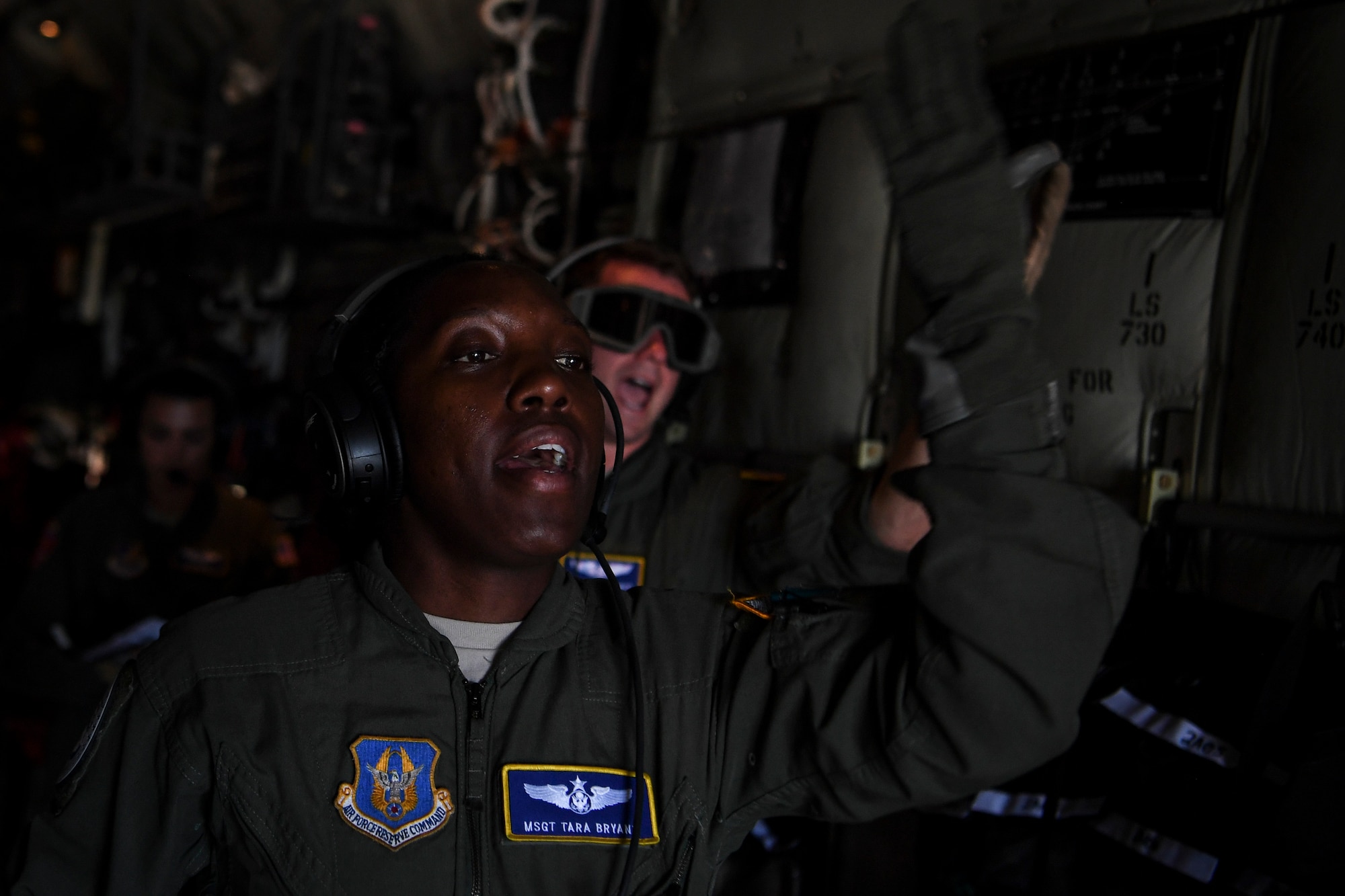 Master Sgt. Tara Bryant, 349th Aeromedical Evacuation Squadron technician, communicates with her crew during an aeromedical mission at Saipan, U.S. Commonwealth of the Northern Mariana Islands, during exercise COPE NORTH 18, Feb. 19, 2018. Approximately 3,000 personnel are participating in COPE NORTH 18, Feb. 19, 2018. COPE NORTH 18 is a Pacific Air Forces sponsored tri-lateral field training exercise designed to develop synergistic and increase interoperability of the U.S. Air Force, Royal Australian Air Force, and Koku Jieitai (Japan Air Self-Defense Force). (U.S. Air Force photo by Staff Sgt. Corey Hook)