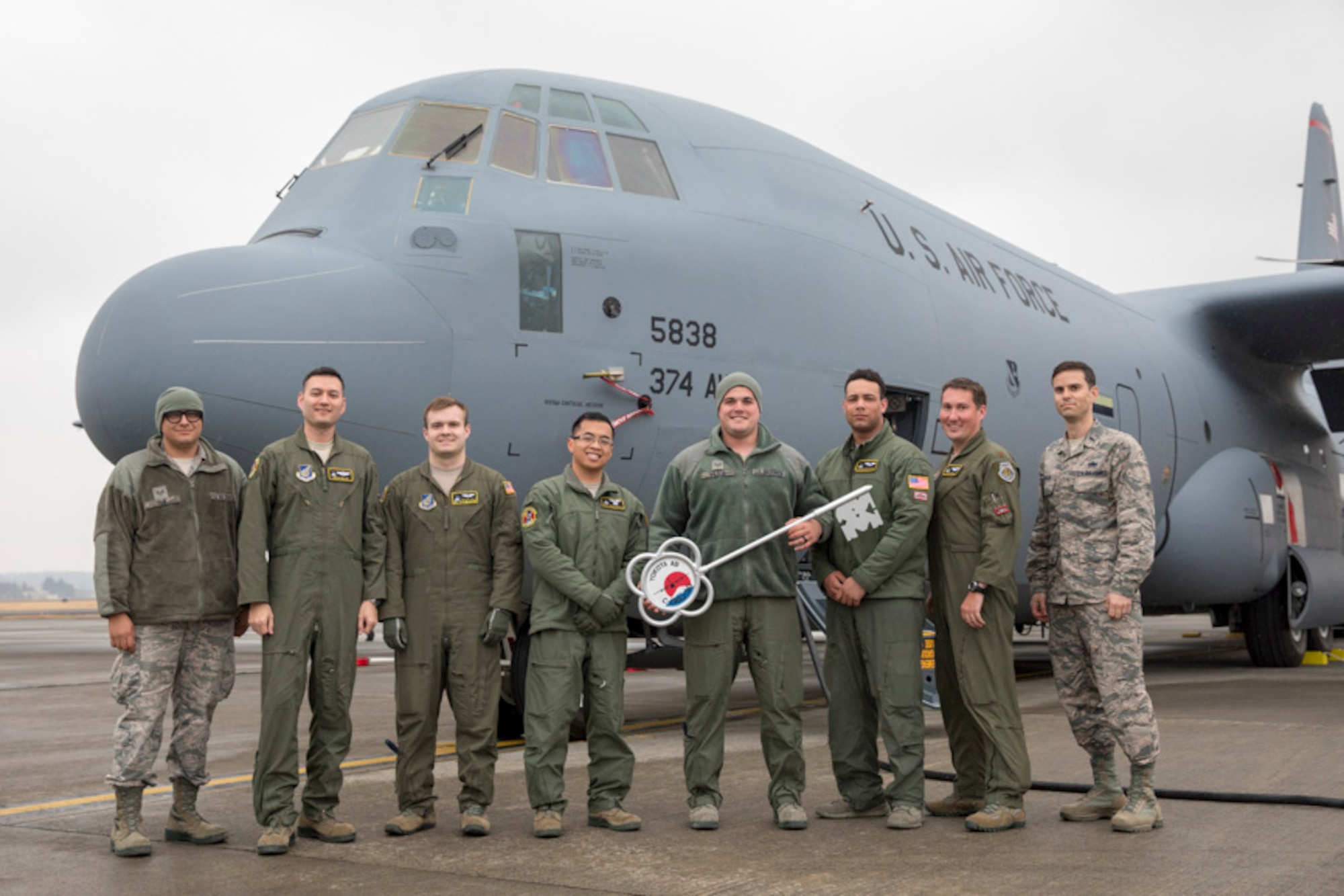 Members of the C-130J Super Hercules number 5838 delivery team pose for a photo