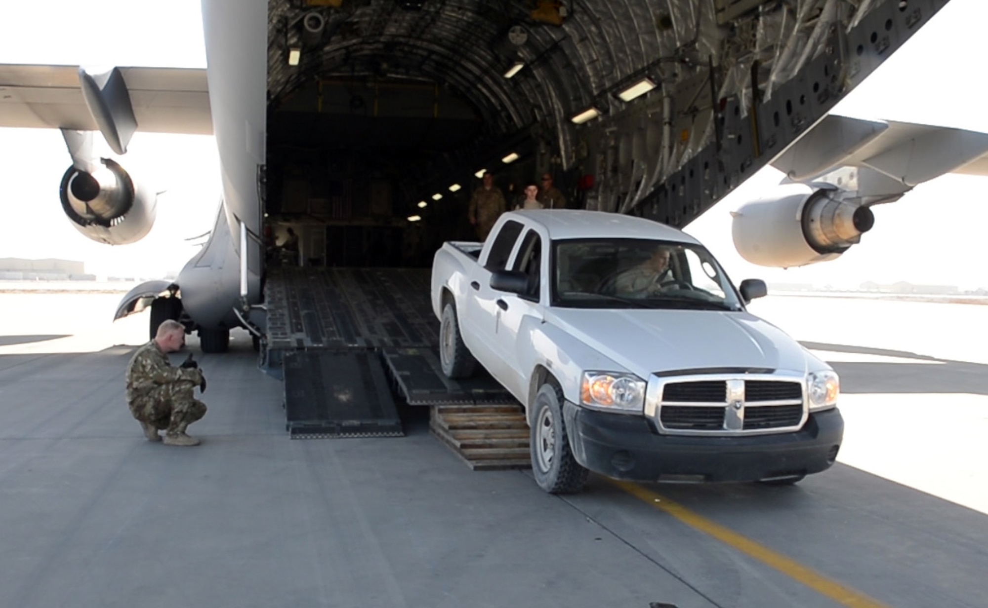 Airmen of the 455th Expeditionary Logistics Readiness Squadron central command material recovery element load a pick-up truck onto a C-17 Globemaster III Feb. 17, 2018 at Bagram Airfield, Afghanistan.