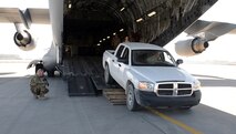 Airmen of the 455th Expeditionary Logistics Readiness Squadron central command material recovery element load a pick-up truck onto a C-17 Globemaster III Feb. 17, 2018 at Bagram Airfield, Afghanistan.