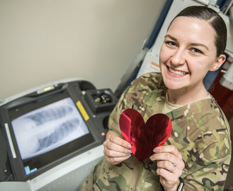 Senior Airman Katie Bryan, X-Ray Technician at Al Dhafra Air Base deployed from Wright-Patterson Air Force Base, poses for a Valentine’s Day photo illustration with her medical equipment on Feb. 13, 2018.  (U.S. Air National Guard Photo Illustration by Tech Sgt Lynette Hoke)