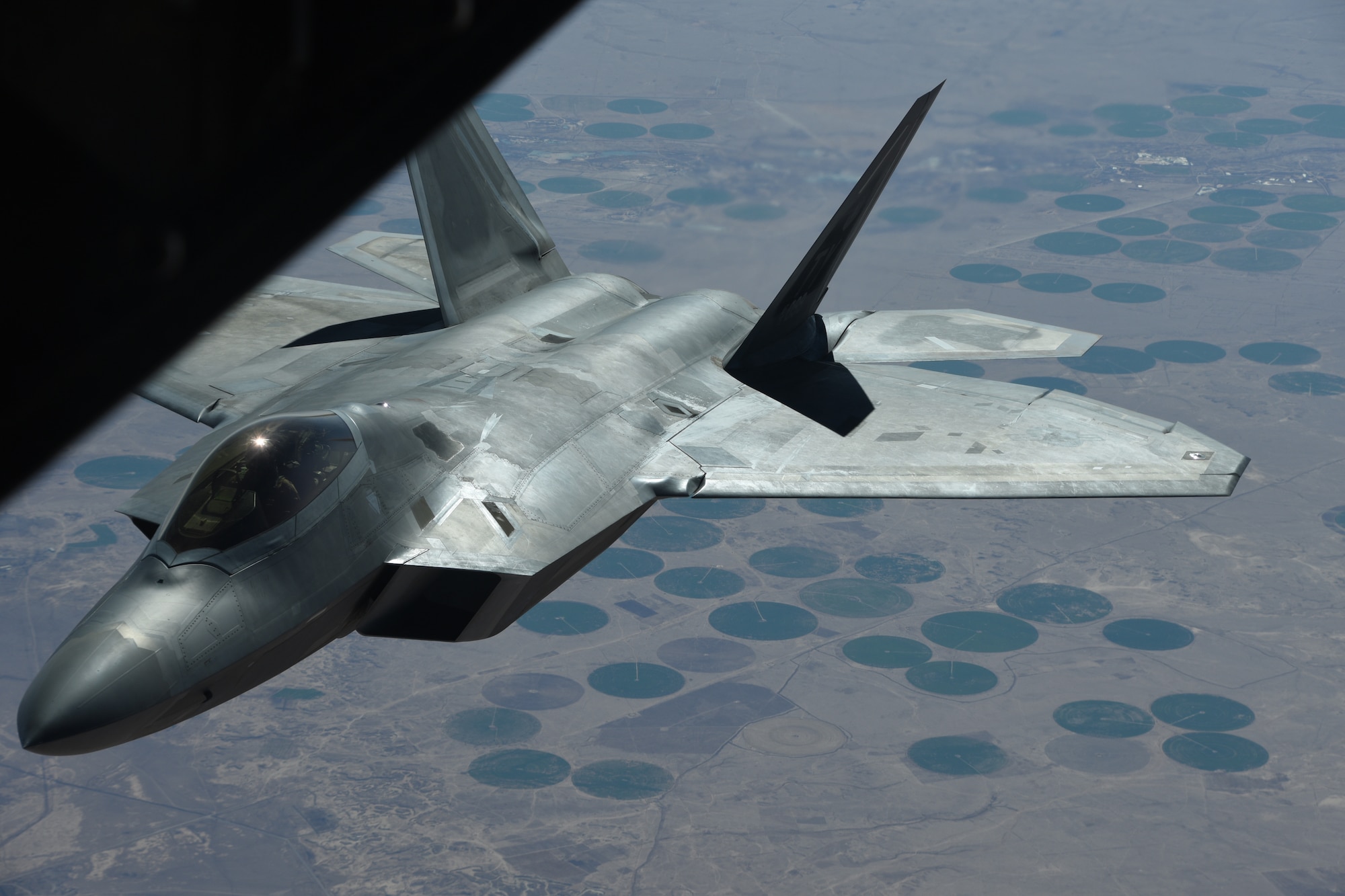 An U.S. Air Force F-22 Raptor departs after receiving fuel from a KC-10 Extender during a mission in support of Operation Inherent Resolve over Syria, Feb. 2, 2018. The F-22's characteristics provide a synergistic effect that ensures F-22 lethality against all advanced air threats. (U.S. Air National Guard photo by Staff Sgt. Colton Elliott)