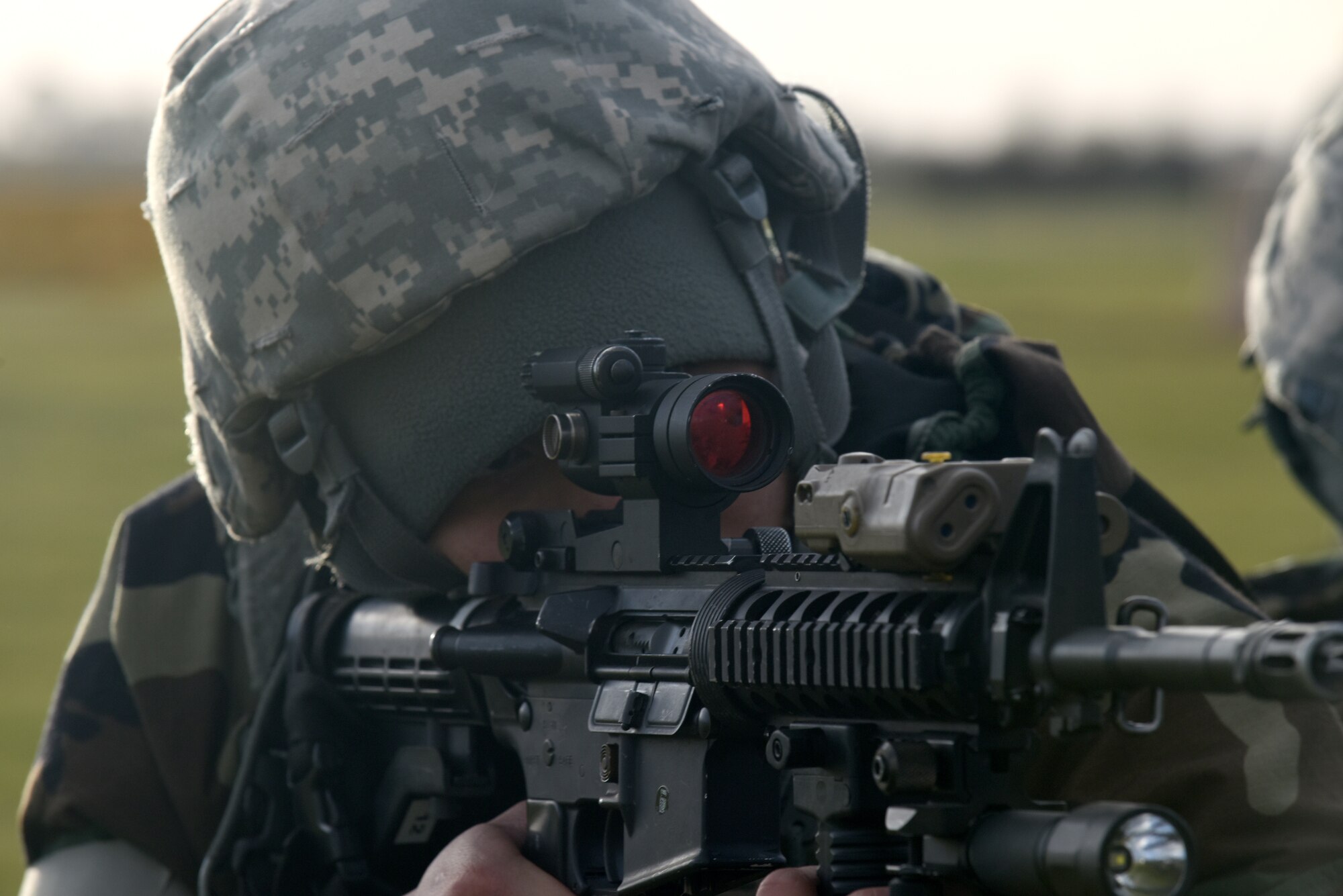 A participant of a chemical, biological, radiological, nuclear and explosive exercise provides cover during a drill at Royal Air Force Feltwell, England, Feb. 12. CBRNE drills provide Airmen a chance to utilize learned techniques in a simulated environment. (U.S. Air Force photo/Airman 1st Class Eli Chevalier)