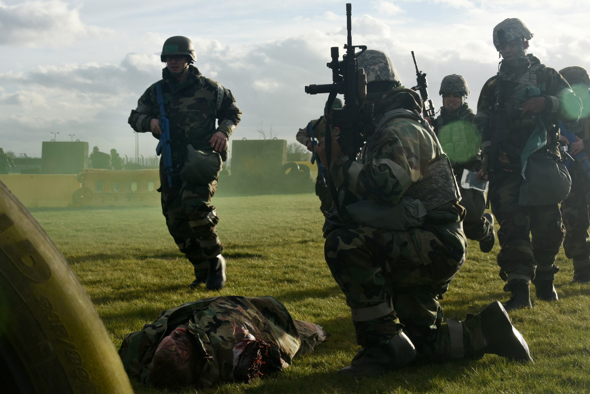 Participants of a chemical, biological, radiological, nuclear and explosive exercise rally near a simulated casualty during a drill at Royal Air Force Feltwell, England, Feb. 12. CBRNE exercises provide Airmen a chance to utilize learned techniques in a training environment. (U.S. Air Force photo/Airman 1st Class Eli Chevalier)