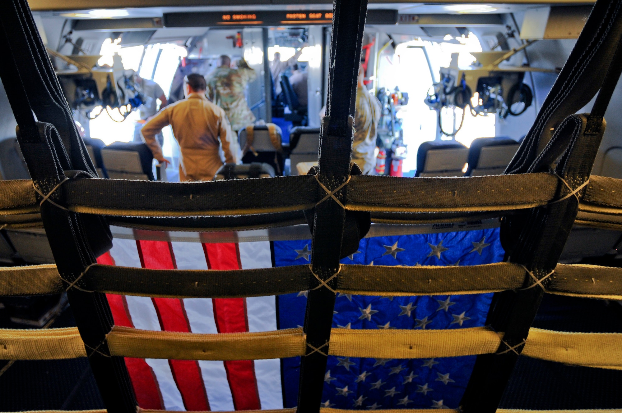 An U.S. flag hangs in the passenger area of a KC-10 Extender before take-off from the 380th Air Expeditionary Wing, Al Dhafra Air Base, United Arab Emirates, Feb. 2, 2018. Flags flown during combat missions are given away as gifts in an effort to thank family and friends for their support to the military. (U.S. Air Force photo by Airman 1st Class D. Blake Browning)