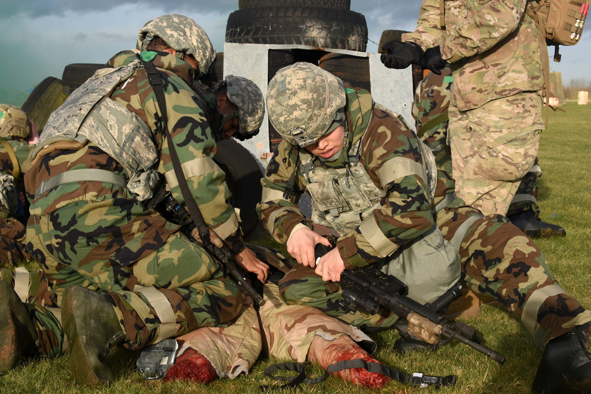 Participants of a chemical, biological, radiological, nuclear and explosive exercise perform self-aid and buddy care on a simulated casualty  during a drill at Royal Air Force Feltwell, England, Feb. 12. CBRNE exercises provide Airmen a chance to utilize learned techniques in a training environment. (U.S. Air Force photo/Airman 1st Class Eli Chevalier)