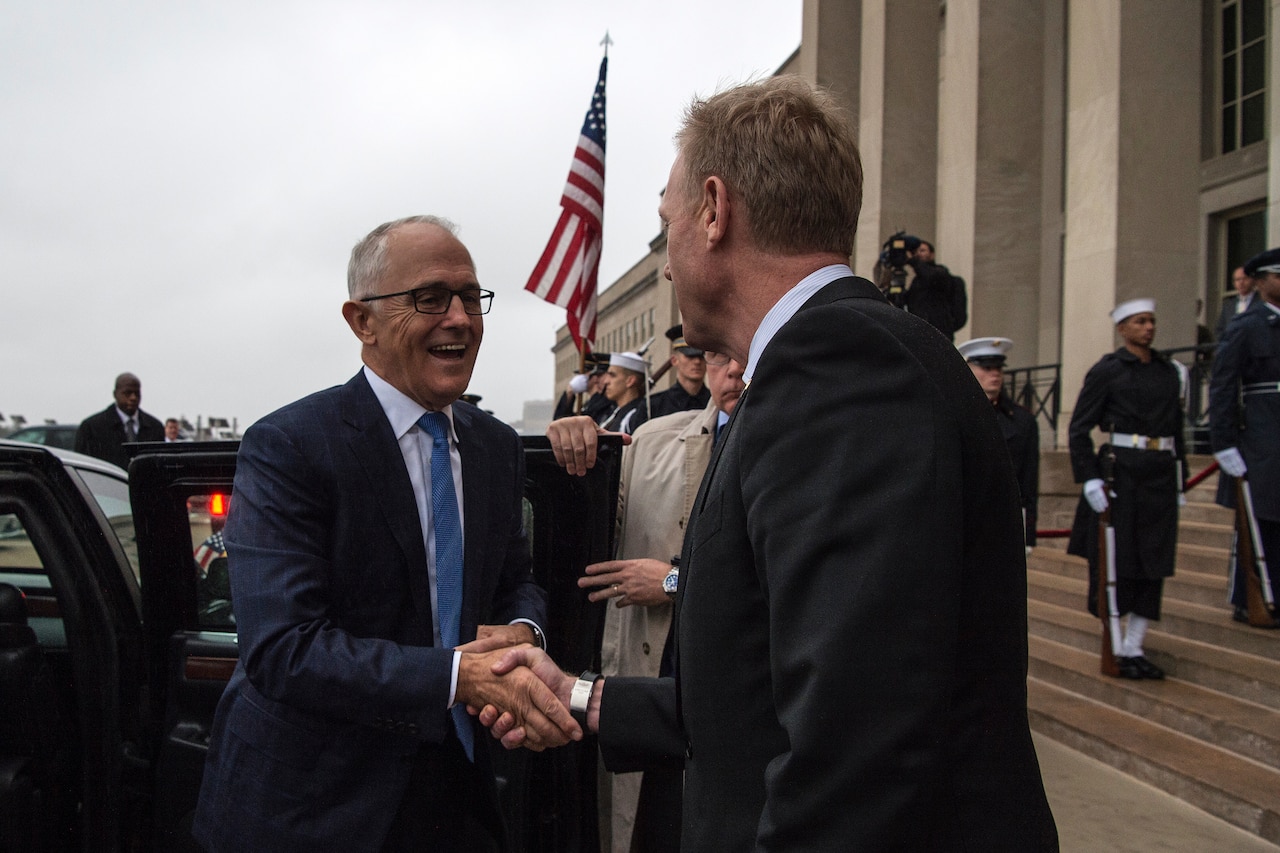 Two leaders shake hands at the Pentagon.