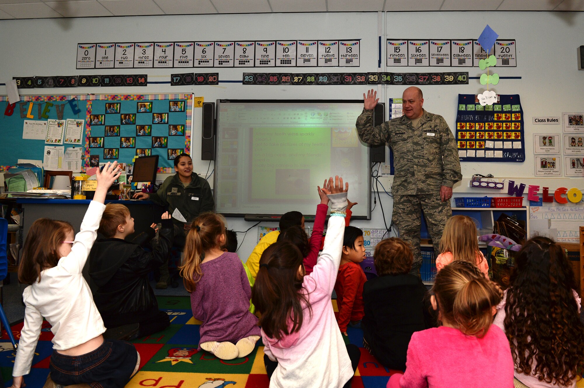 Col. Joseph A. Muhlbauer, the chief of dental professional staff assigned to the 48th Dental Squadron, interacts with children at Lakenheath Elementary School at Royal Air Force Lakenheath, England, Feb. 20, 2018. Muhlbauer shared fun stories of the dental clinic to facilitate positive reactions to the idea of dental visits. (U.S. Air Force photo/Airman 1st Class Shanice Williams-Jones)