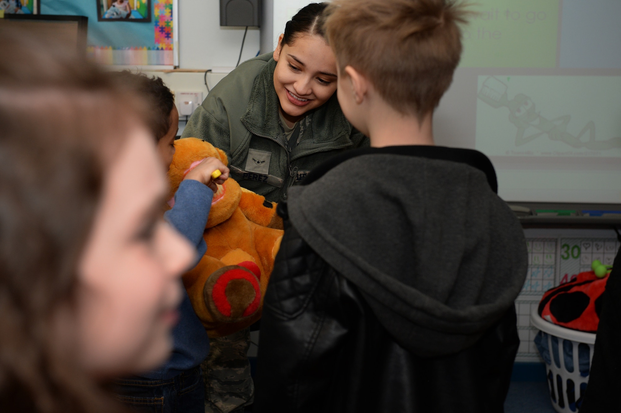 Airman Mariah M. Perez, a dental technician assigned to the 48th Dental Squadron, smiles at a child at the Lakenheath Elementary School at Royal Air Force Lakenheath, England, Feb. 20, 2018. Perez said she volunteered to participate in the National Children’s Dental Health Month campaign because it’s amazing to be a part of taking care of children’s dental needs outside of the clinic. (U.S. Air Force photo/Airman 1st Class Shanice Williams-Jones)