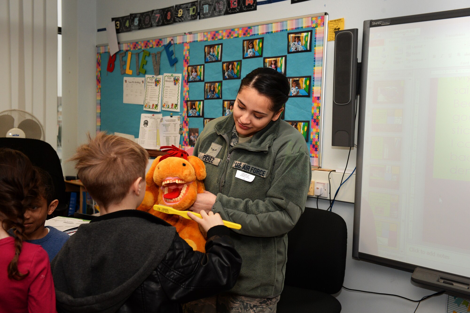 Airman Mariah M. Perez, a dental technician assigned to the 48th Dental Squadron, holds a stuffed animal, and teaching aide, at the Lakenheath Elementary School at Royal Air Force Lakenheath, England, Feb. 20, 2018. National Children’s Dental Health Month aims to raise awareness and promote the benefits of good oral hygiene to children. (U.S. Air Force photo/Airman 1st Class Shanice Williams-Jones)