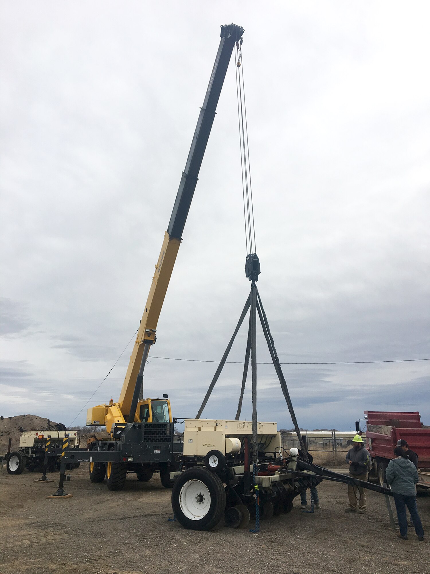 A crane raises a seed drill in preparation for its transfer from the 366th Civil Engineer Squadron to the U.S. Fish and Wildlife Service.