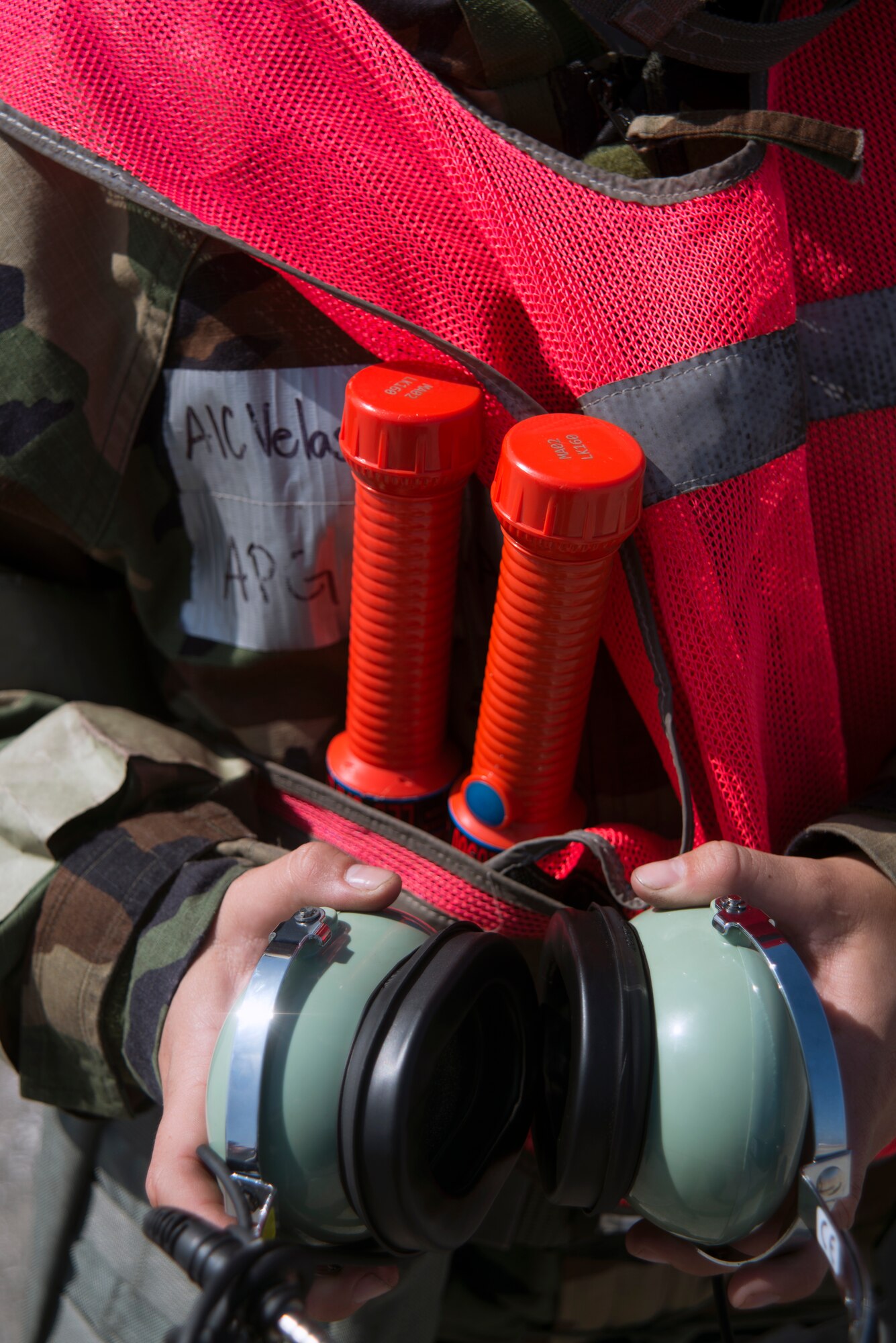 U.S. Air Force Airman 1st Class Victoria Velasquez, a crew chief assigned to the 6th Maintenance Squadron, puts on an interphone headset before signaling a KC-135 Stratotanker aircraft during a training exercise at MacDill Air Force Base, Fla., Feb. 14, 2018.