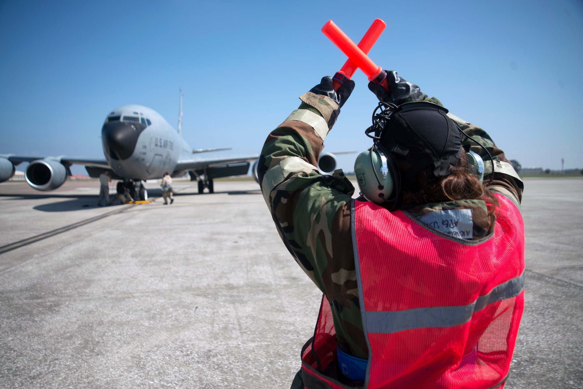 U.S. Air Force Airman 1st Class Victoria Velasquez, a crew chief assigned to the 6th Maintenance Squadron, marshals a KC-135 Stratotanker aircraft during a training exercise at MacDill Air Force Base, Fla., Feb. 14, 2018