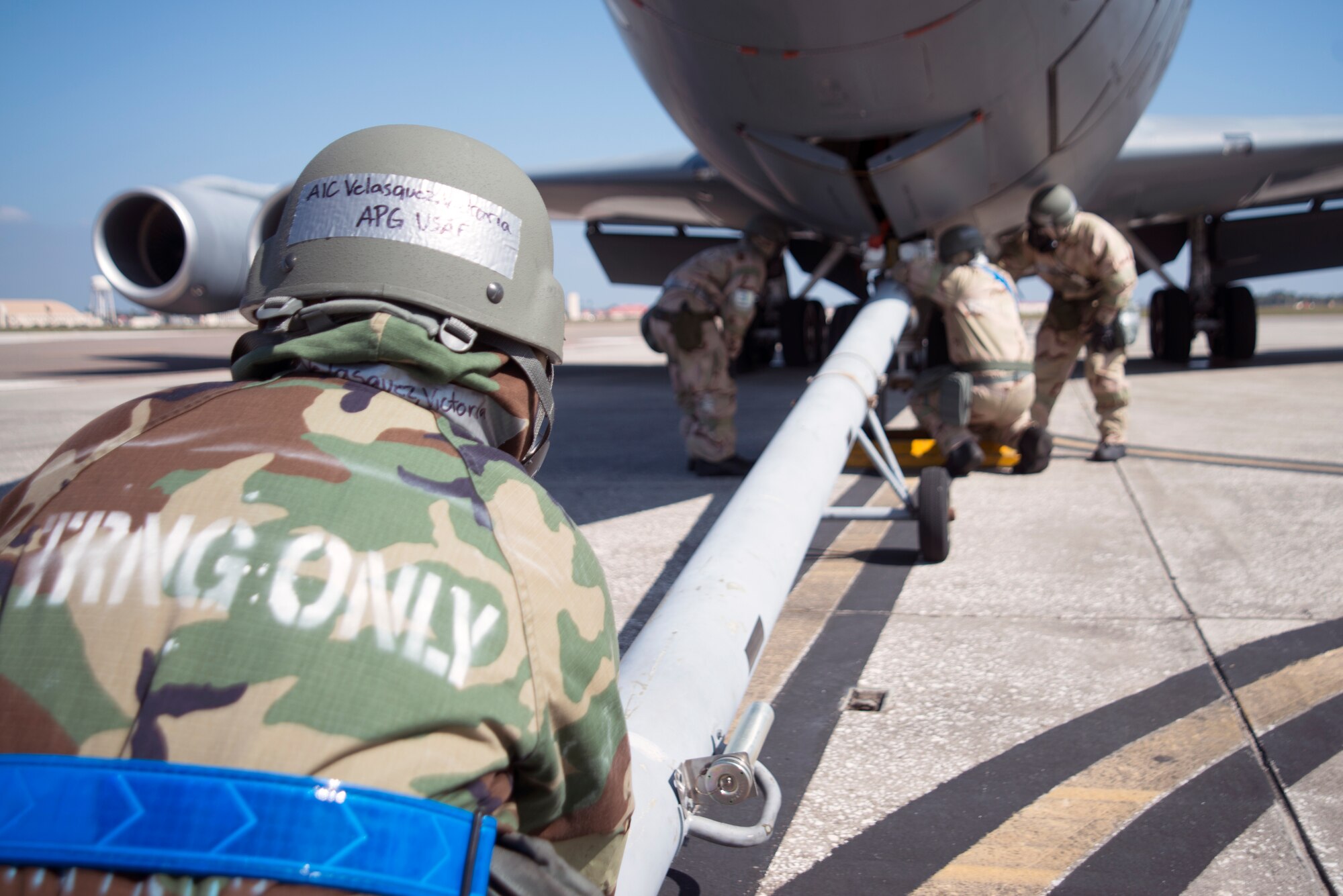 U.S. Air Force Airman 1st Class Victoria Velasquez, a crew chief assigned to the 6th Aircraft Maintenance Squadron, attaches a tow bar onto a KC-135 Stratotanker aircraft during a training exercise at MacDill Air Force Base, Fla., Feb. 14, 2018.