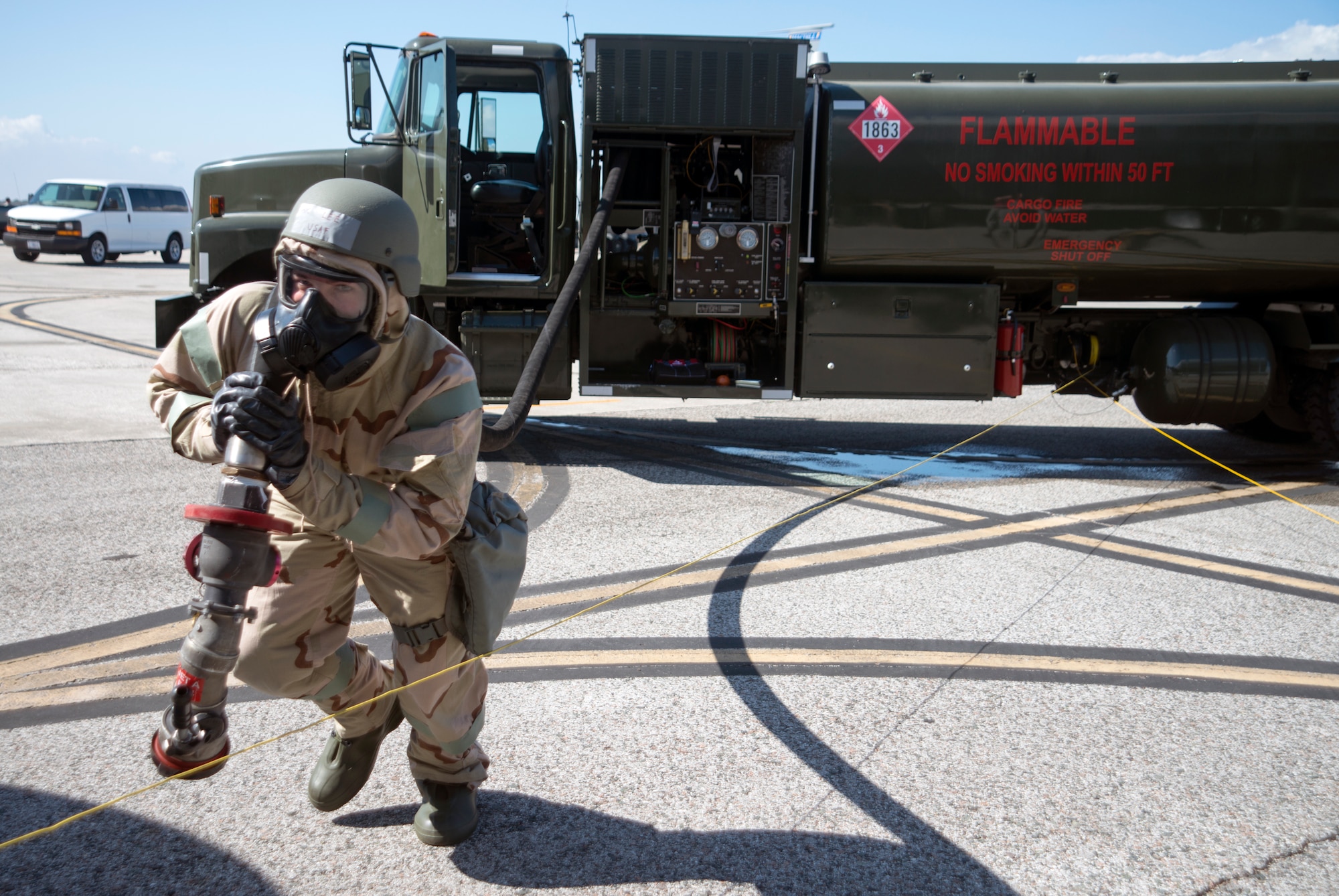 U.S. Air Force Airman 1st Class Koty Lee, a fuels distribution operator assigned to the 6th Logistics Readiness Squadron (LRS), lugs a fuel hose to a KC-135 Stratotanker during a training exercise at MacDill Air Force Base, Fla., Feb. 14, 2018.