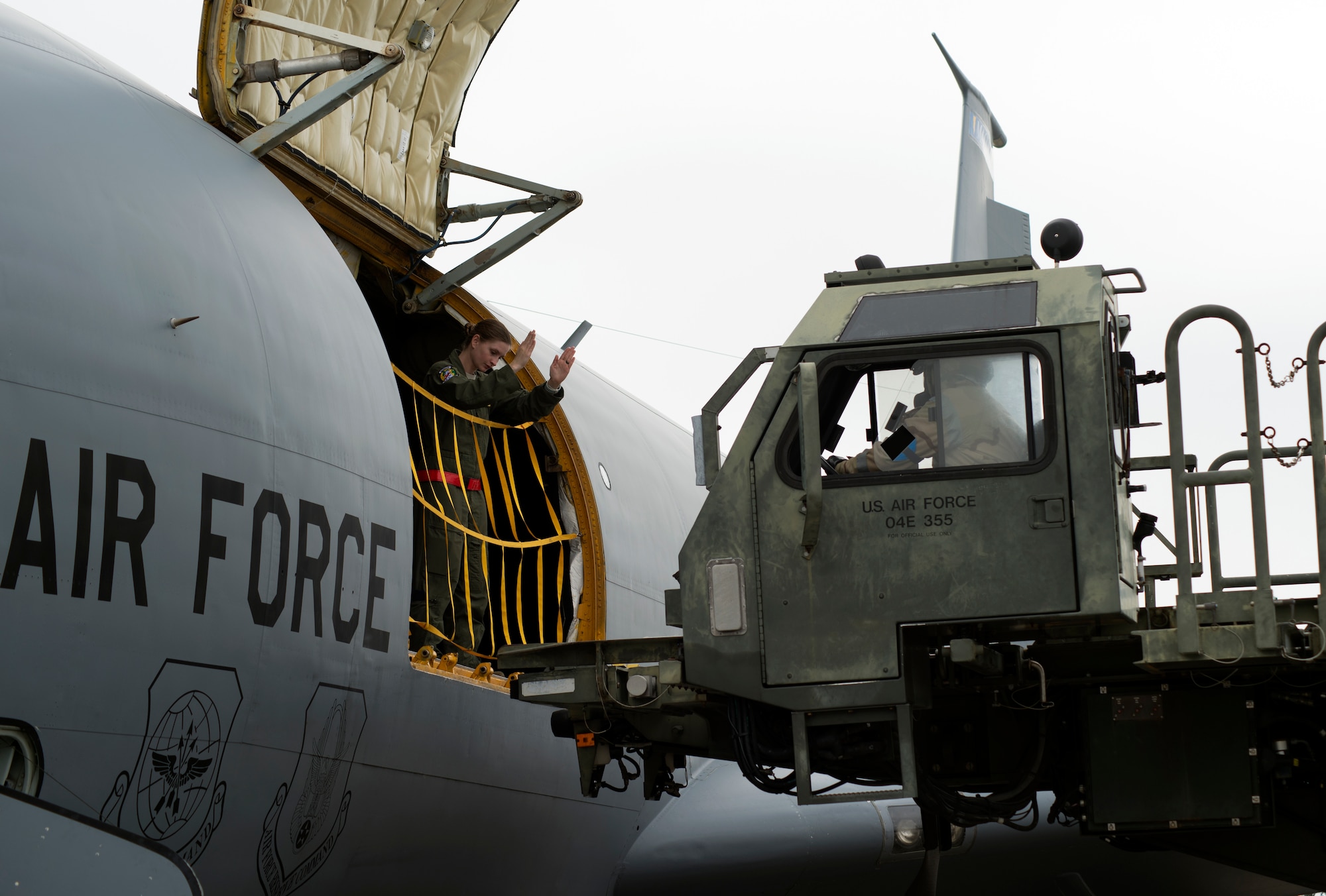 U.S. Air Force Airman 1st Class Douglas Boehm, right, a passenger service representative assigned to the 6th Logistics Readiness Squadron (LRS), raises a 25K halvorsen loader during a training exercise at MacDill Air Force Base, Fla., Feb. 14, 2018.