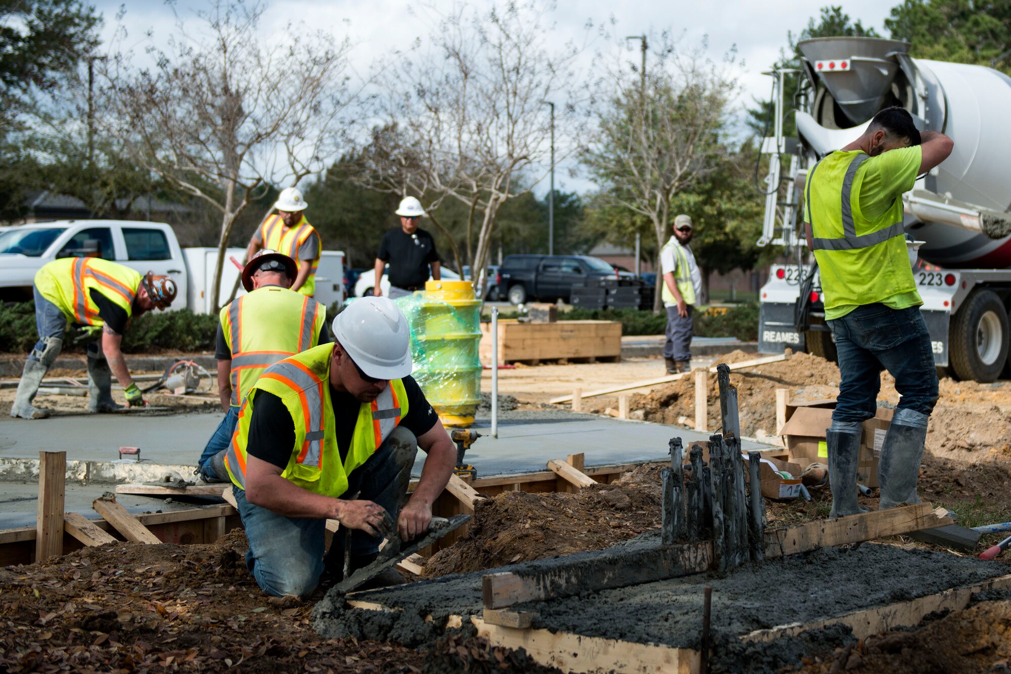 Construction personnel work on laying cement during the reconstruction of Mitchell Gate, Feb. 21, 2018, at Moody Air Force Base, Ga.  The 23d Civil Engineer Squadron partnered with civilian contractors to reconstruct the gate in an effort to improve the security posture with improved anti-terrorism force protection barriers. (U.S. Air Force photo by Airman 1st Class Erick Requadt)