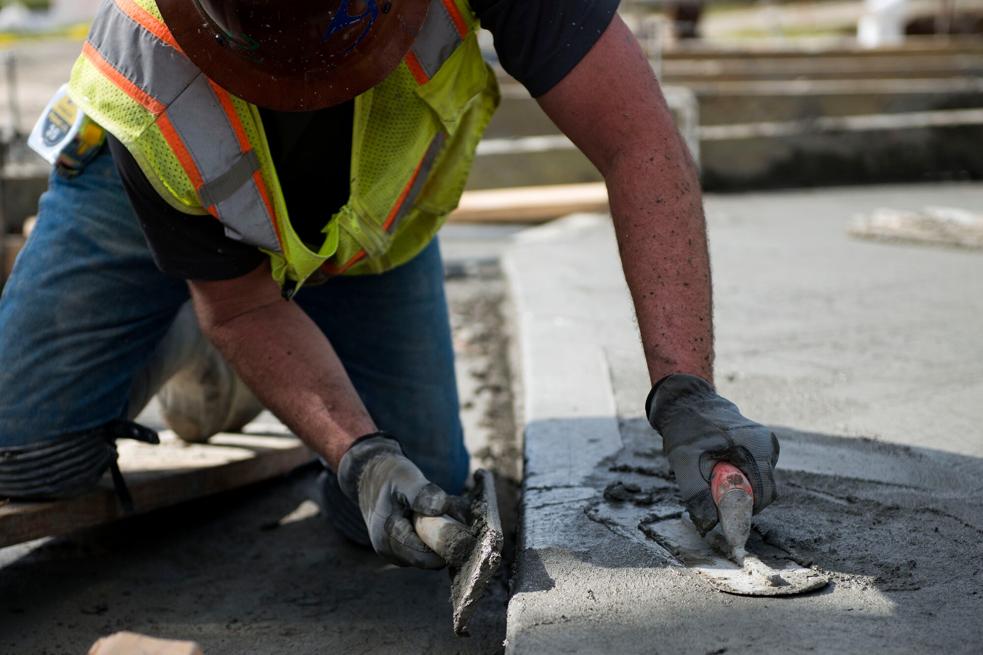 Jacob Skelton, construction working superintendent, smooths out a corner of cement during the reconstruction of Mitchell Gate, Feb. 21, 2018, at Moody Air Force Base, Ga. The 23d Civil Engineer Squadron partnered with civilian contractors to reconstruct the gate in an effort to improve the security posture with improved anti-terrorism force protection barriers. (U.S. Air Force photo by Airman 1st Class Erick Requadt)