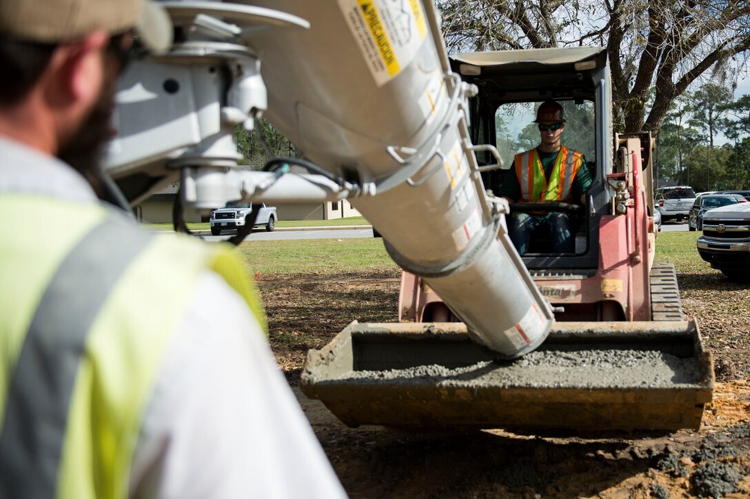 Joey Goethe, construction superintendent, fills a loader with cement during the reconstruction of Mitchell Gate, Feb. 21, 2018, at Moody Air Force Base, Ga. The 23d Civil Engineer Squadron partnered with civilian contractors to reconstruct the gate in an effort to improve the security posture with improved anti-terrorism force protection barriers. (U.S. Air Force photo by Airman 1st Class Erick Requadt)