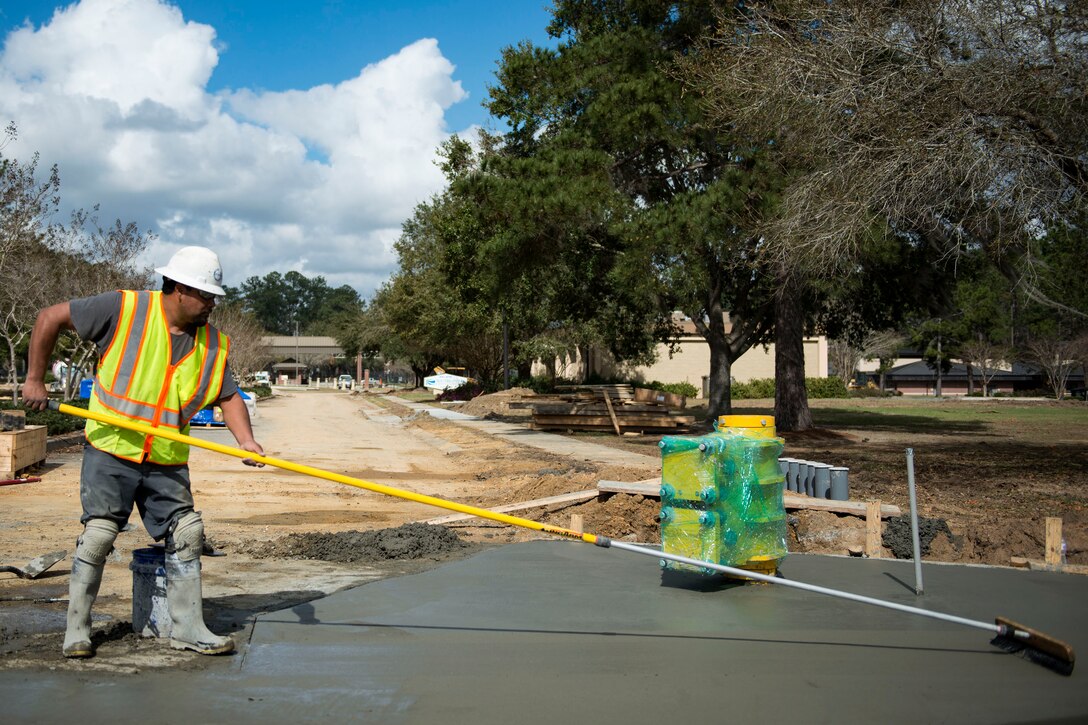 Juan Zaragoza, construction concrete finisher, smooths out cement during the reconstruction of Mitchell Gate, Feb. 21, 2018, at Moody Air Force Base, Ga. The 23d Civil Engineer Squadron partnered with civilian contractors to reconstruct the gate in an effort to improve the security posture with improved anti-terrorism force protection barriers. (U.S. Air Force photo by Airman 1st Class Erick Requadt)
