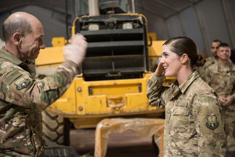 General Mike Holmes, commander of Air Combat Command, salutes Staff Sgt. Aimee Grills, from the 557th Expeditionary RED HORSE Squadron, for her distinguished service during a visit at an undisclosed location February 16, 2018. The 557 ERHS is deployed from Hurlburt Field, Florida, and has been heavily involved in construction projects that will be crucial to Coalition success going forward. (U.S. Air Force photo by Staff Sgt. Joshua Kleinholz)