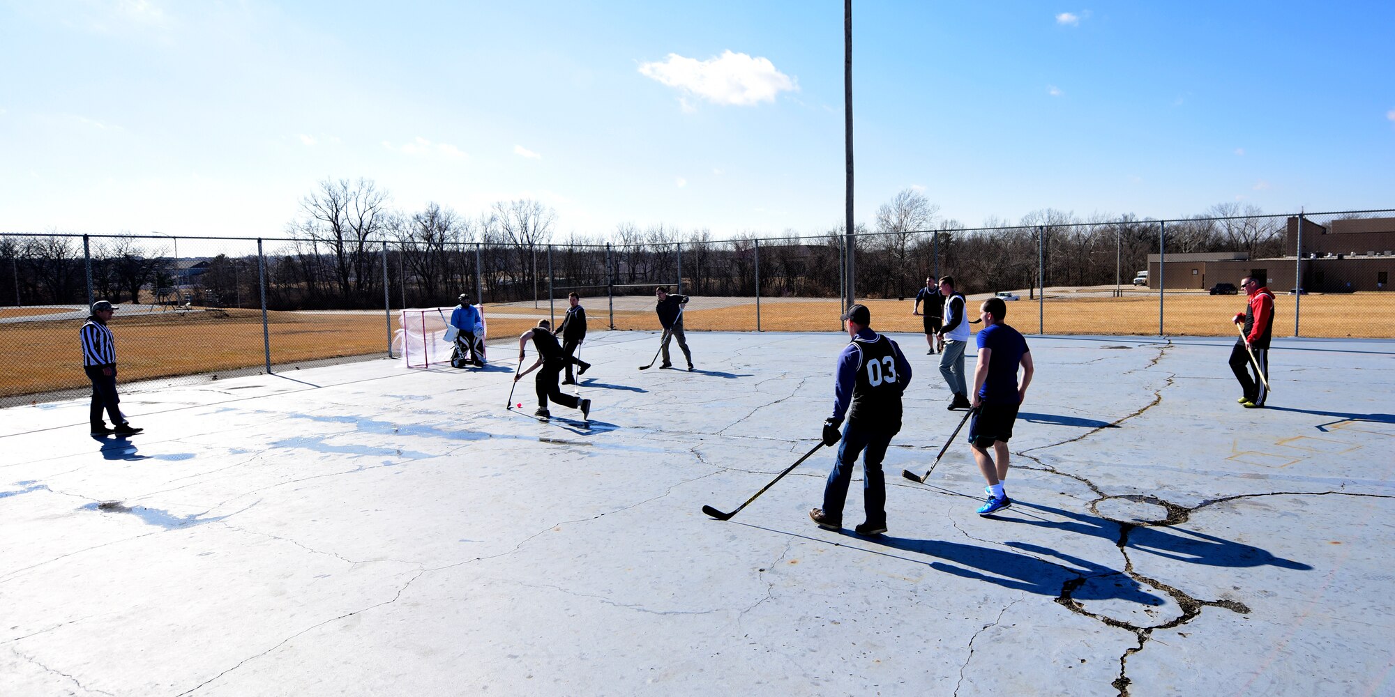 Members of Team Whiteman participate in the first extramural hockey practice at Whiteman Air Force Base, Mo., Feb. 17, 2018. The old skate park outside the fitness center provides the teams enough space to practice techniques and play games. (U.S. Air Force photo by Staff Sgt. Danielle Quilla)