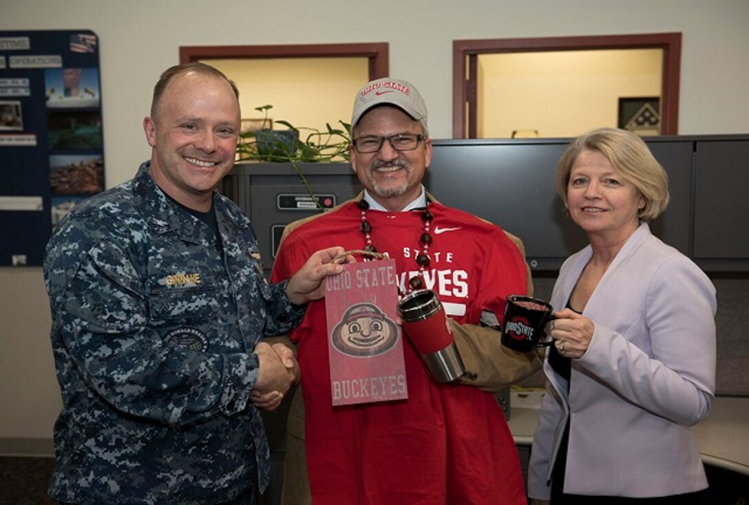 Capt. Ginnane and Brenda Minnema present Brian Lewer, with an OSU grab bag.