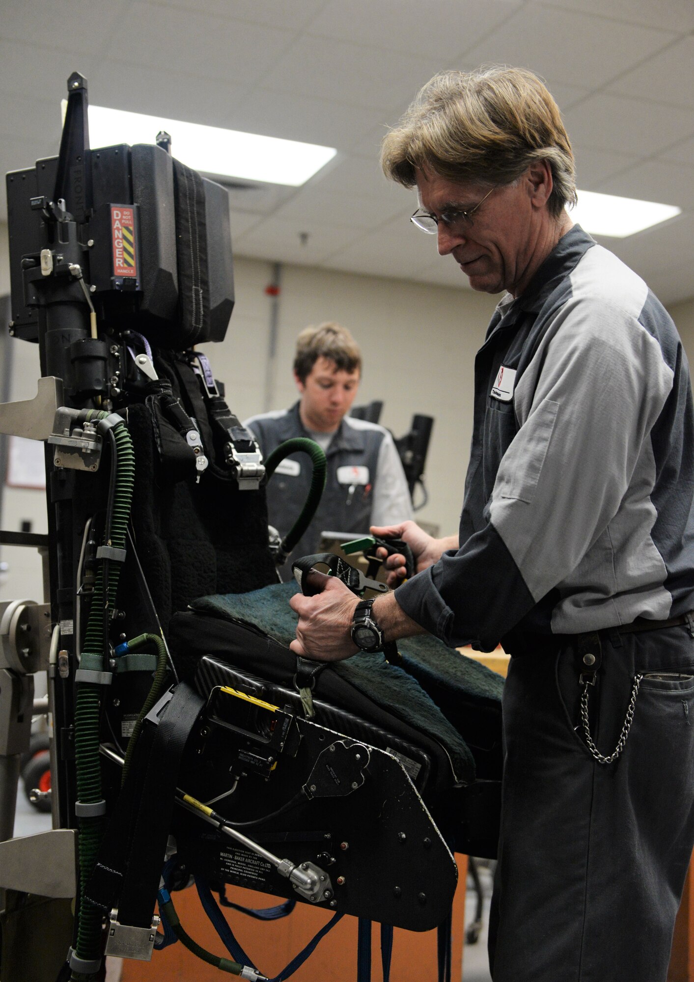Roy Norman, L3 Technologies T-38C Talon egress mechanic installs a survival kit onto a T-38 ejection seat, Feb. 14, 2018, on Columbus Air Force Base, Mississippi. After the final inspection of each T-38 seat the survival kit is reinstalled, this process ensures the seat is up to date and ready to be used in case of an emergency. (U.S. Air Force photo by Airman 1st Class Keith Holcomb)