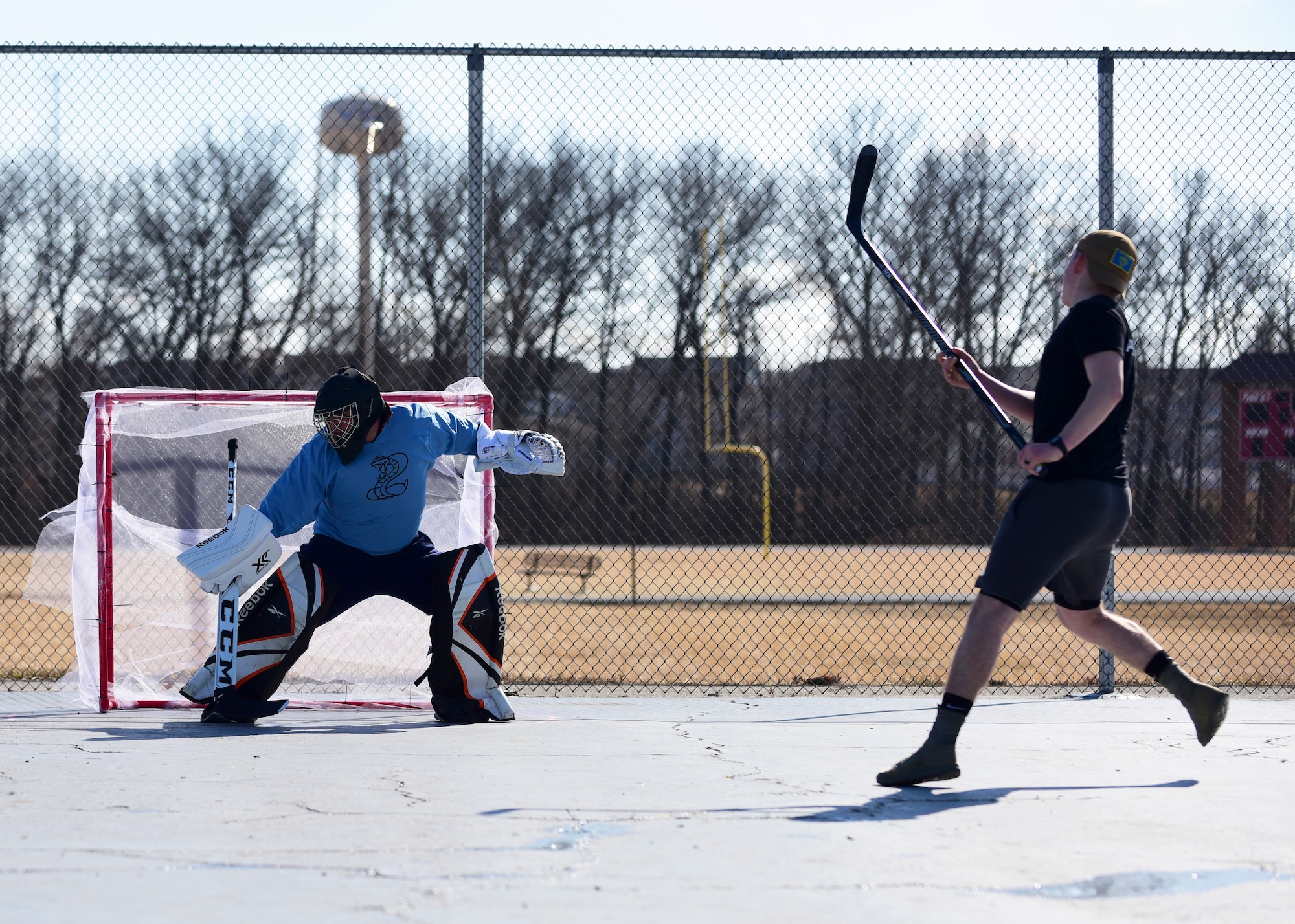 Members of Team Whiteman participate in the first extramural hockey practice at Whiteman Air Force Base, Mo., Feb. 17, 2018. Only one goal and goalkeeper were available for the initial meeting. (U.S. Air Force photo by Staff Sgt. Danielle Quilla)