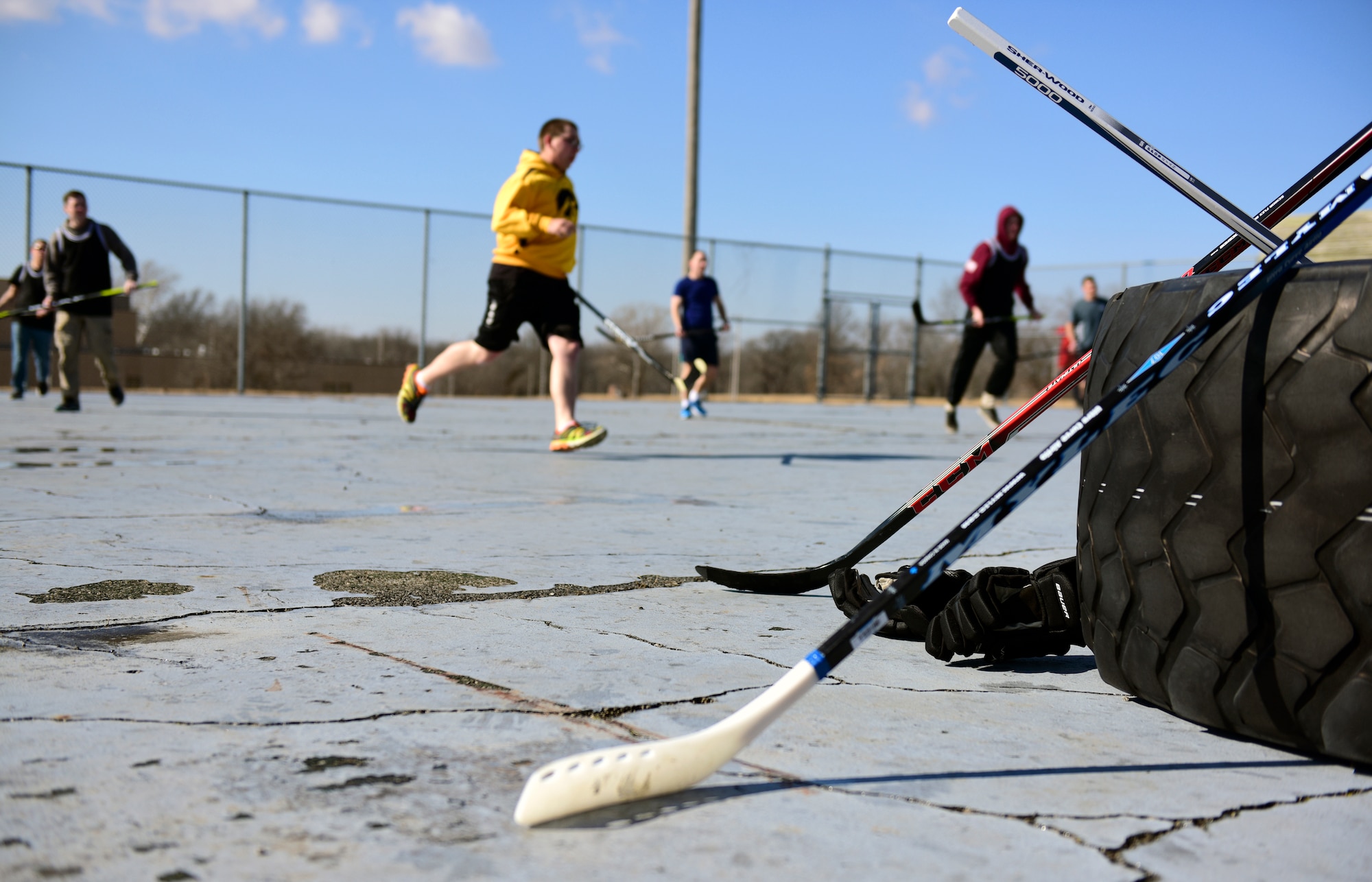 Members of Team Whiteman participate in the first extramural hockey practice at Whiteman Air Force Base, Mo., Feb. 17, 2018. Hockey sticks were available for members who did not have their own gear and jerseys were used to distinguish the teams. (U.S. Air Force photo by Staff Sgt. Danielle Quilla)